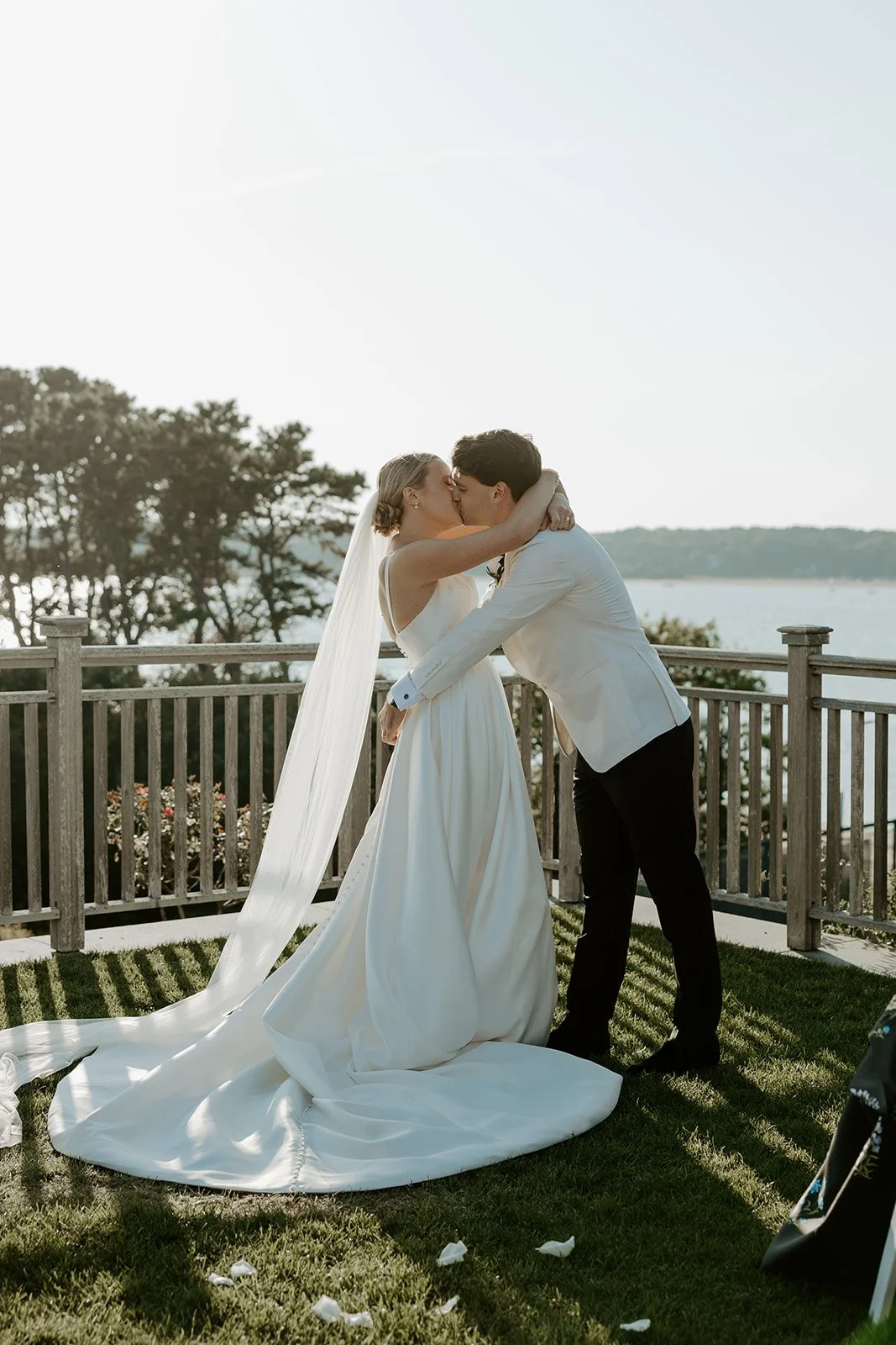 A couple's first kiss at their cape cod wedding