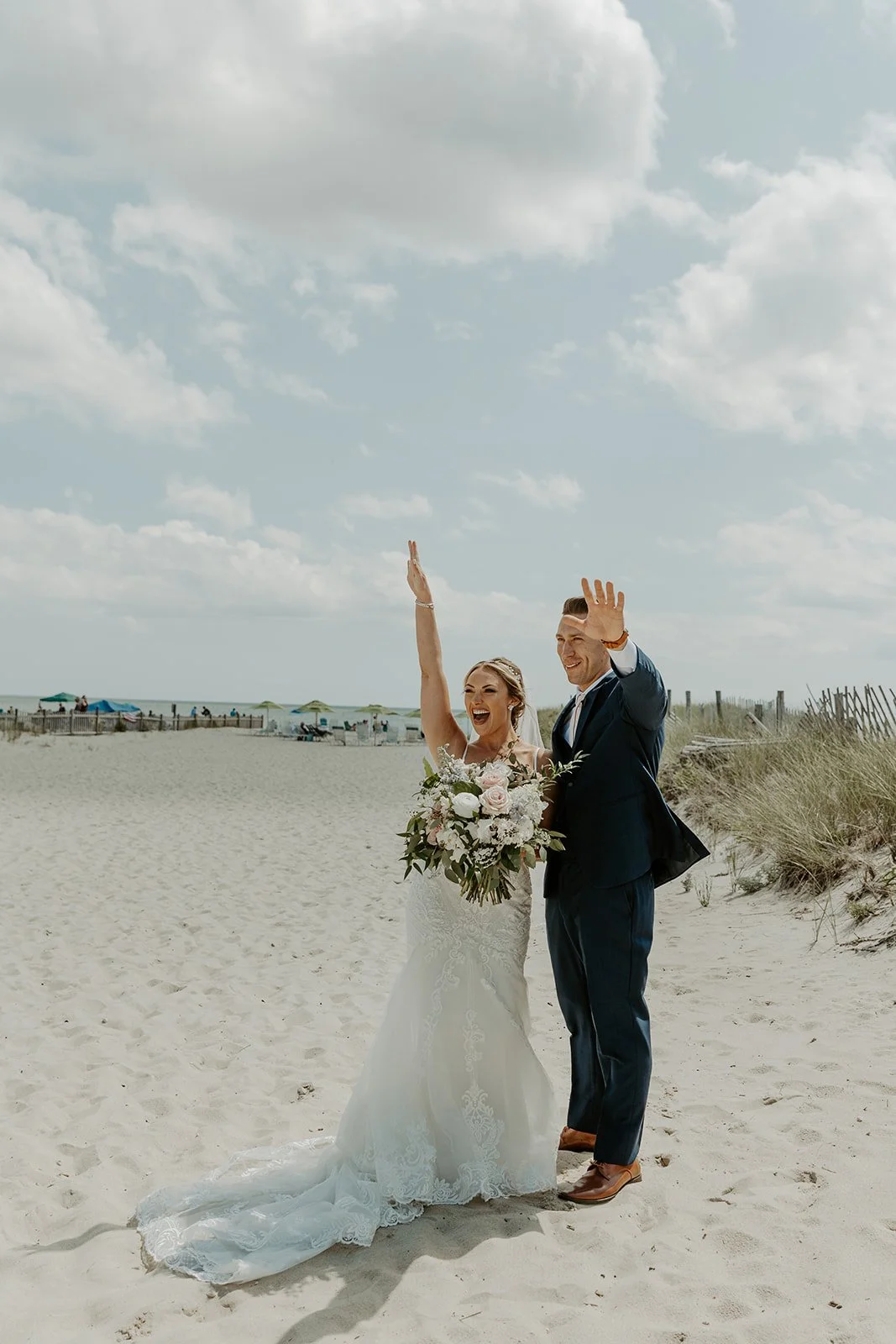 A bride and groom cheering after their first look