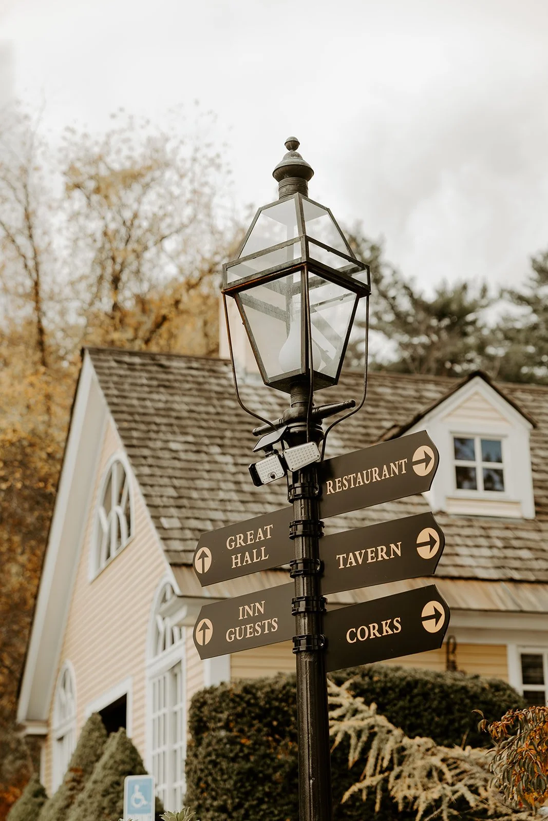 A lantern with street signs at Bedford Village Inn