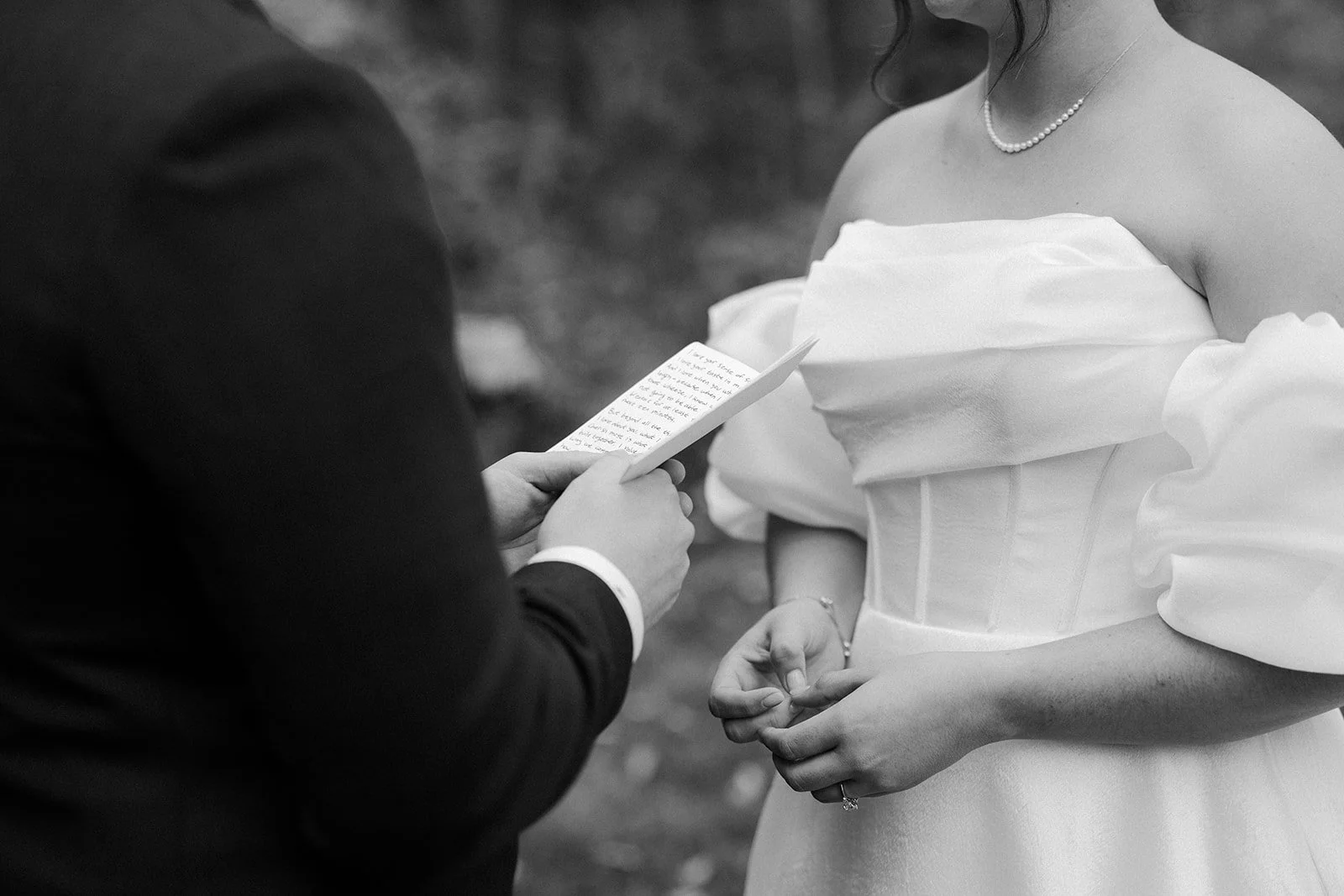 A bride and groom reading private vows