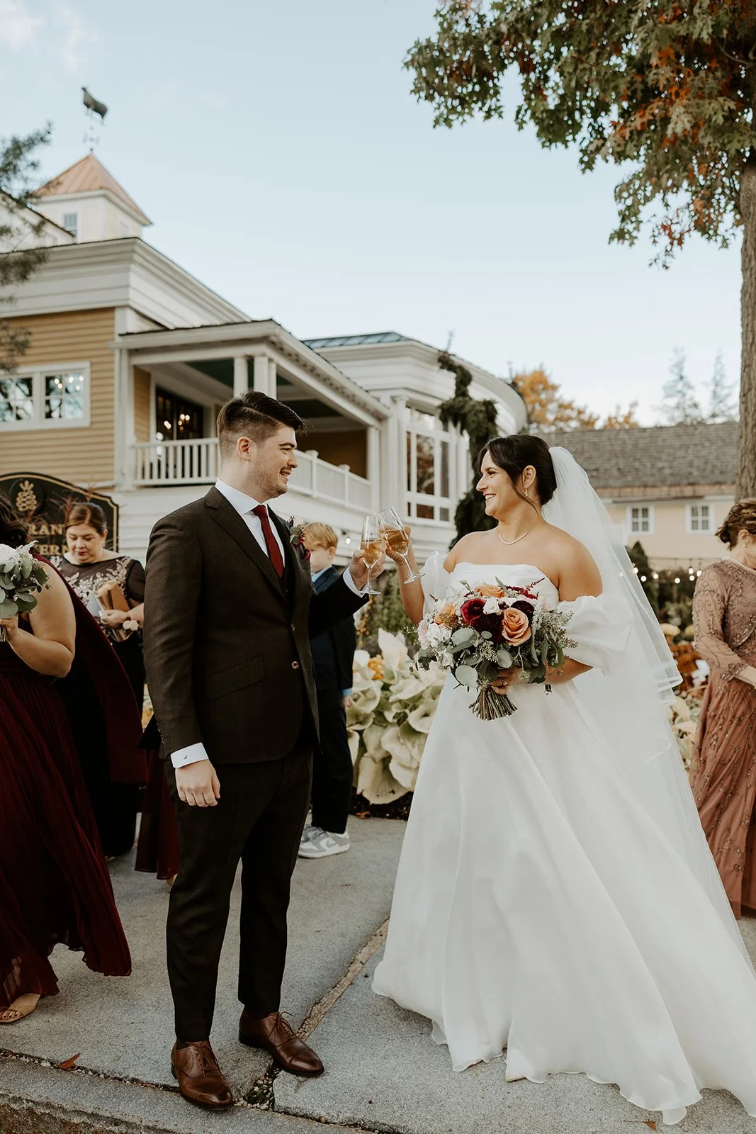 A bride and groom sharing champagne after their wedding ceremony