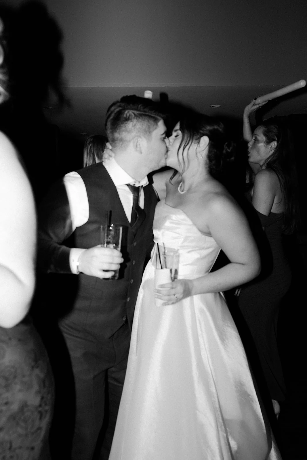 A bride and groom kissing at their wedding reception