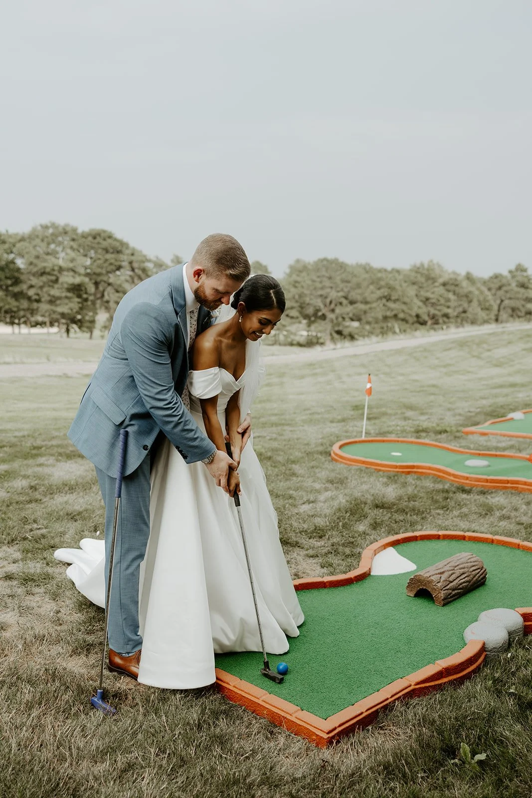 A bride and groom playing mini golf at a waverly oaks wedding