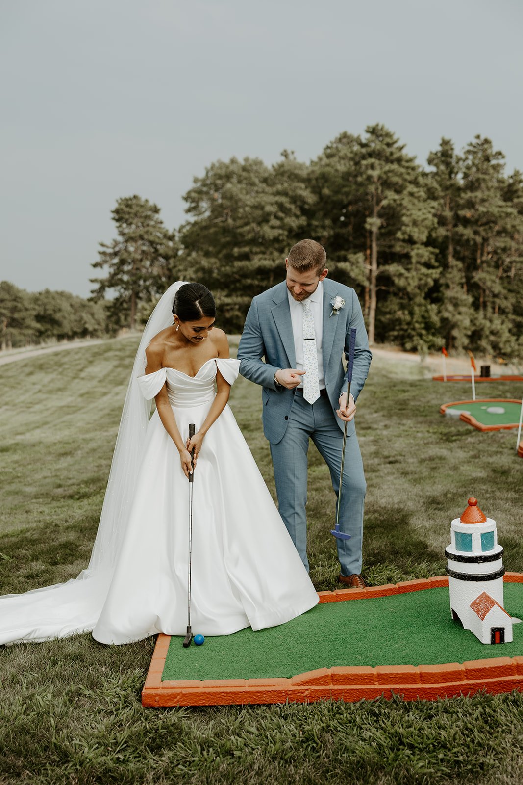 A bride and groom playing mini golf at waverly oaks