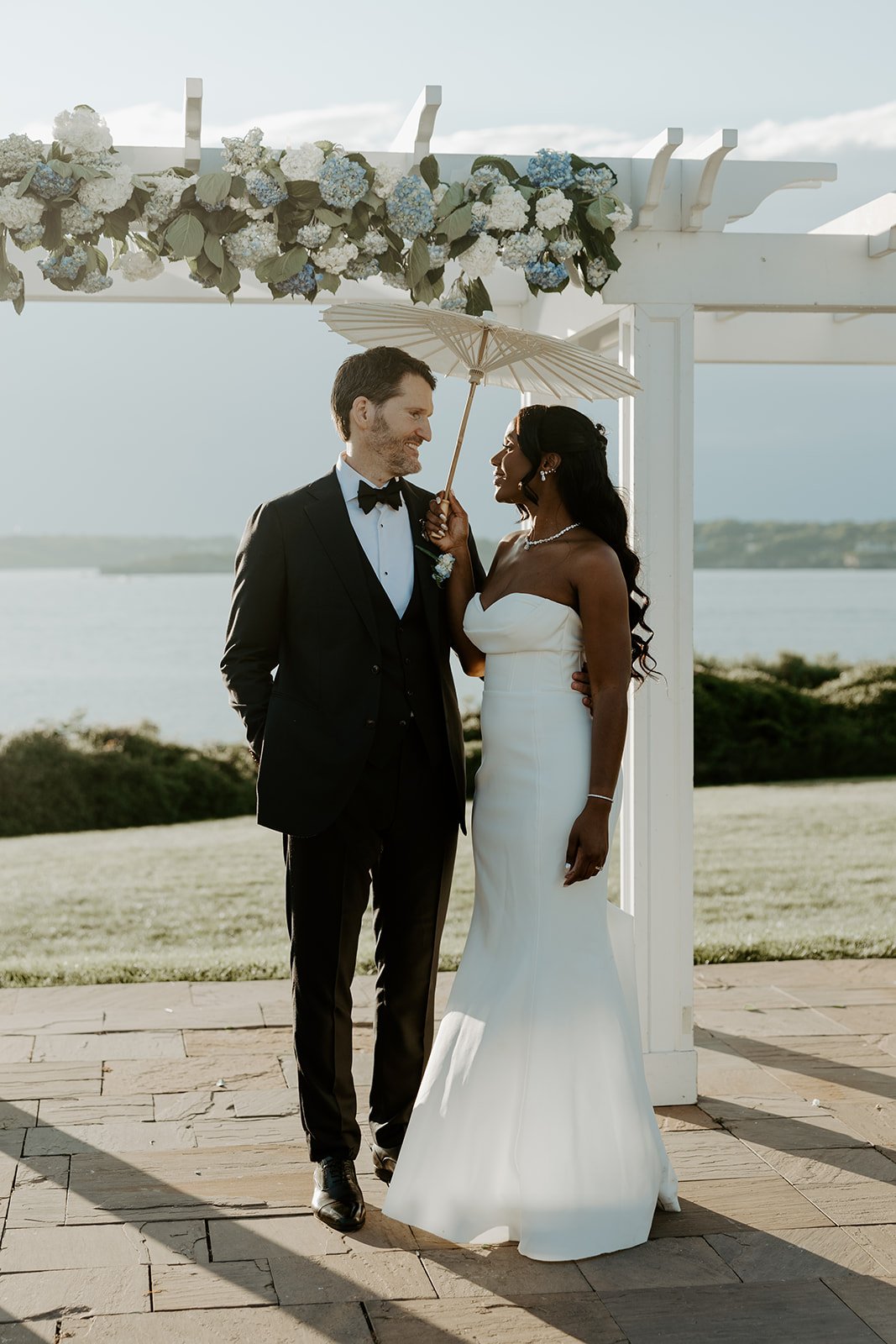 A bride and groom posing for wedding photos at their Rhode Island wedding venue