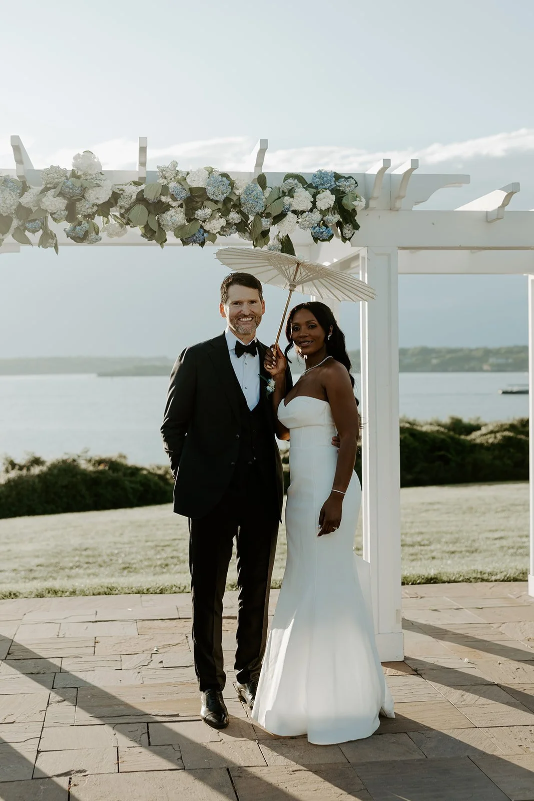 A bride and groom posing for wedding photos at their Rhode Island wedding venue