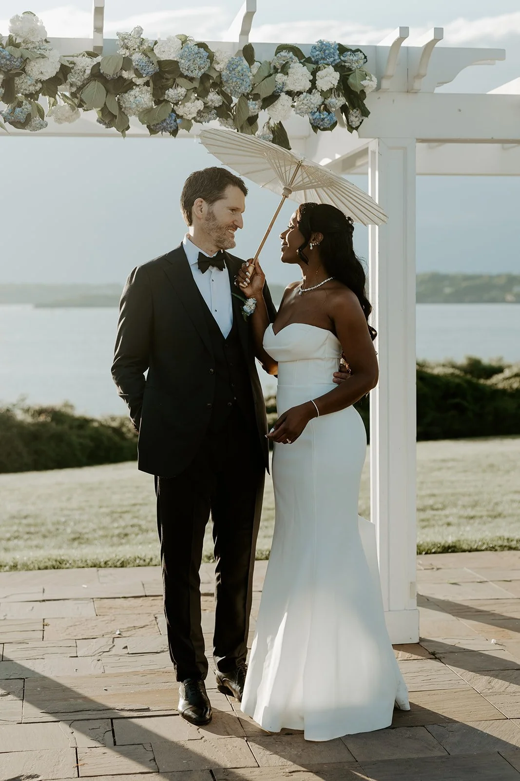 A bride and groom posing for wedding photos at their Rhode Island wedding venue