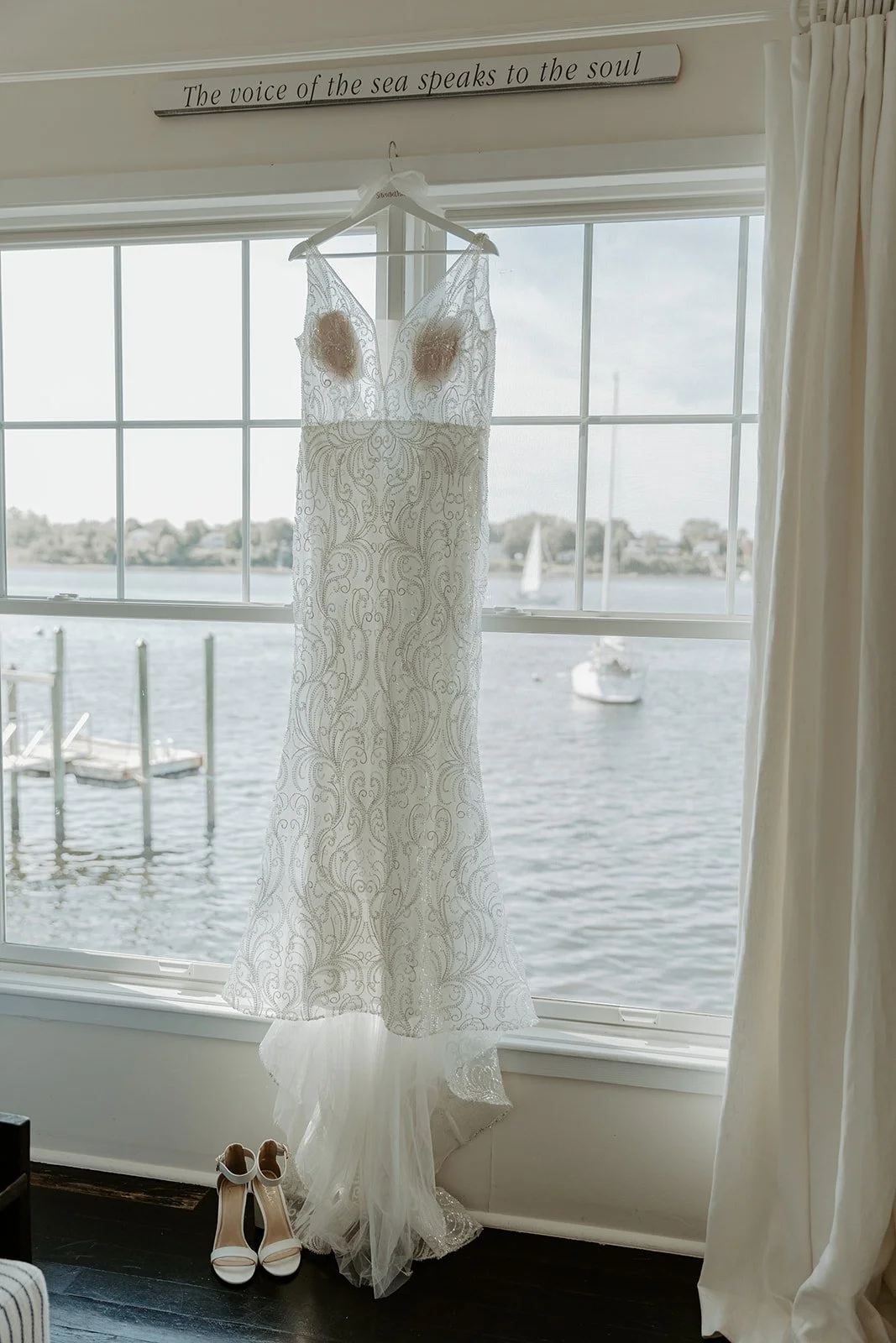 A wedding dress hanging up in getting ready suite at Mount Hope Farm