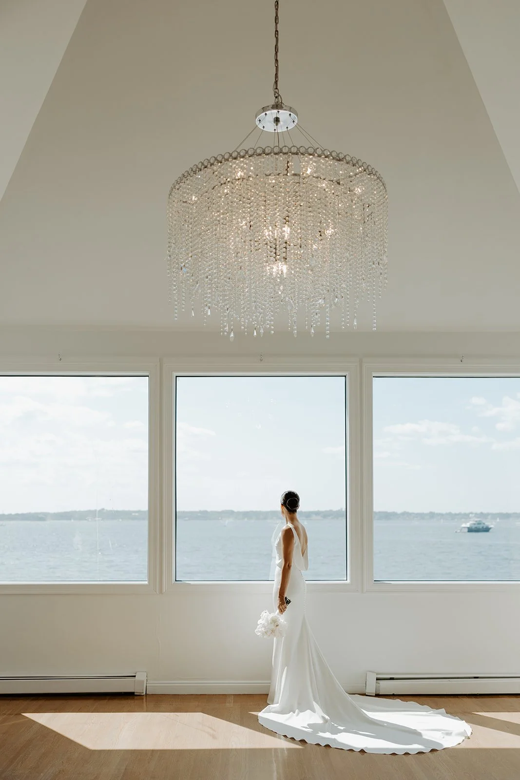 A bride posing for portraits in the bridal suite at Rhode Island wedding venue Belle Mer