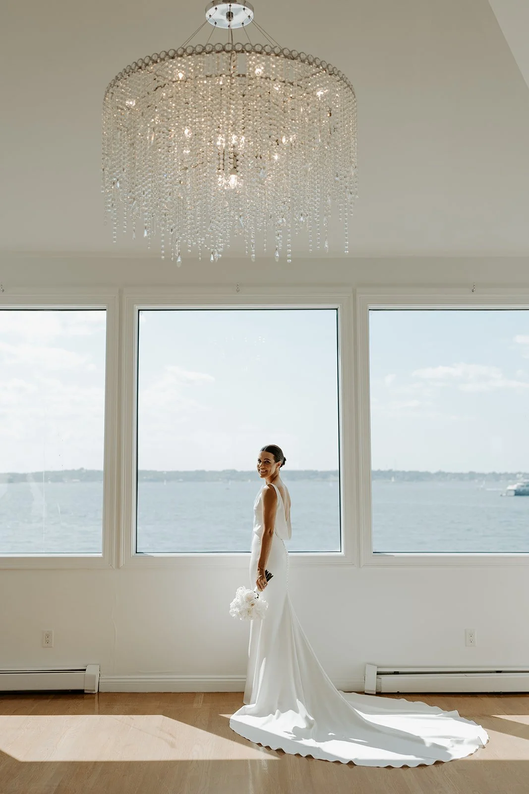 A bride posing for portraits in the bridal suite at Rhode Island wedding venue Belle Mer