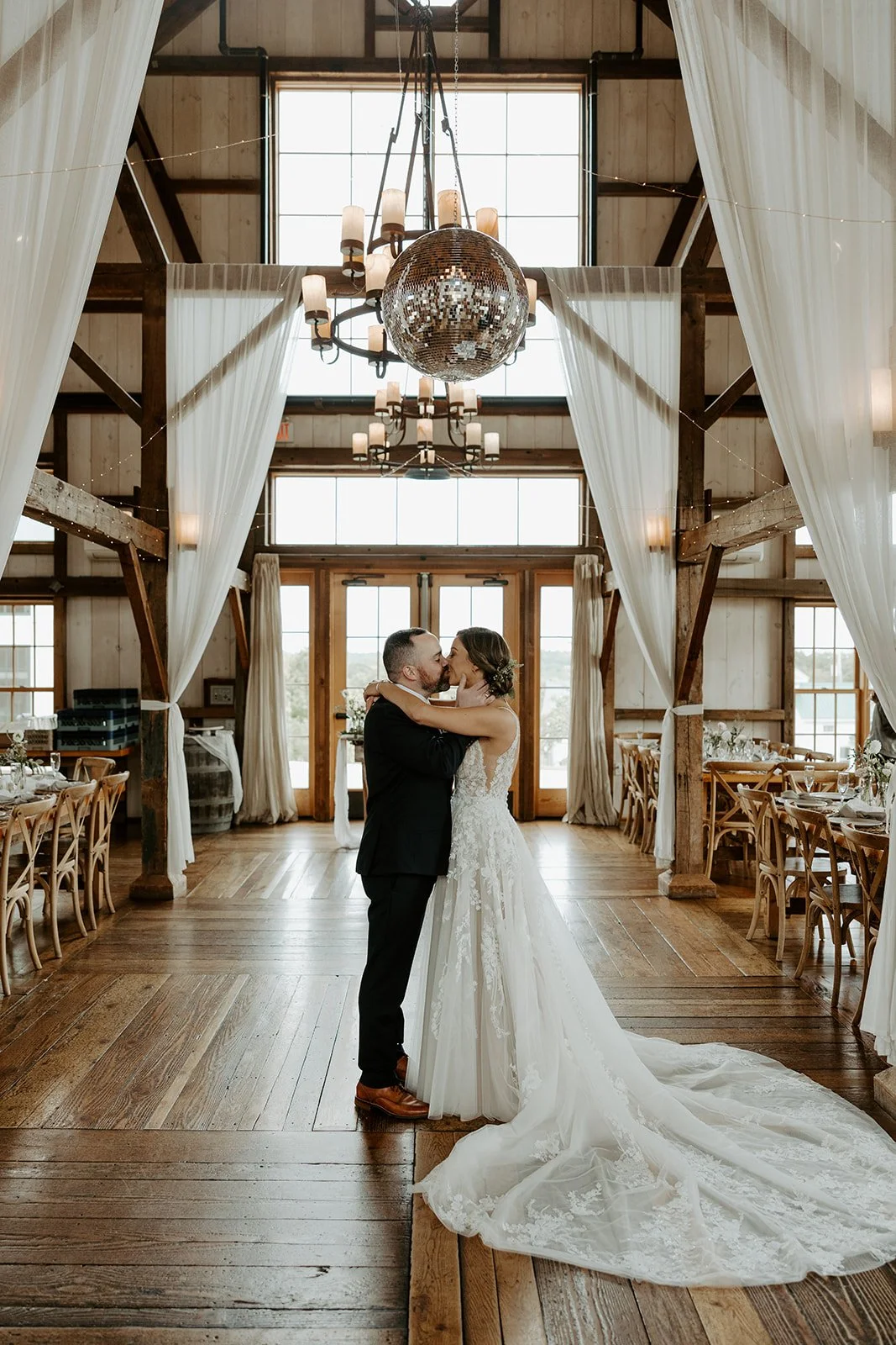 A bride and groom kissing in a barn at Valley View Farm