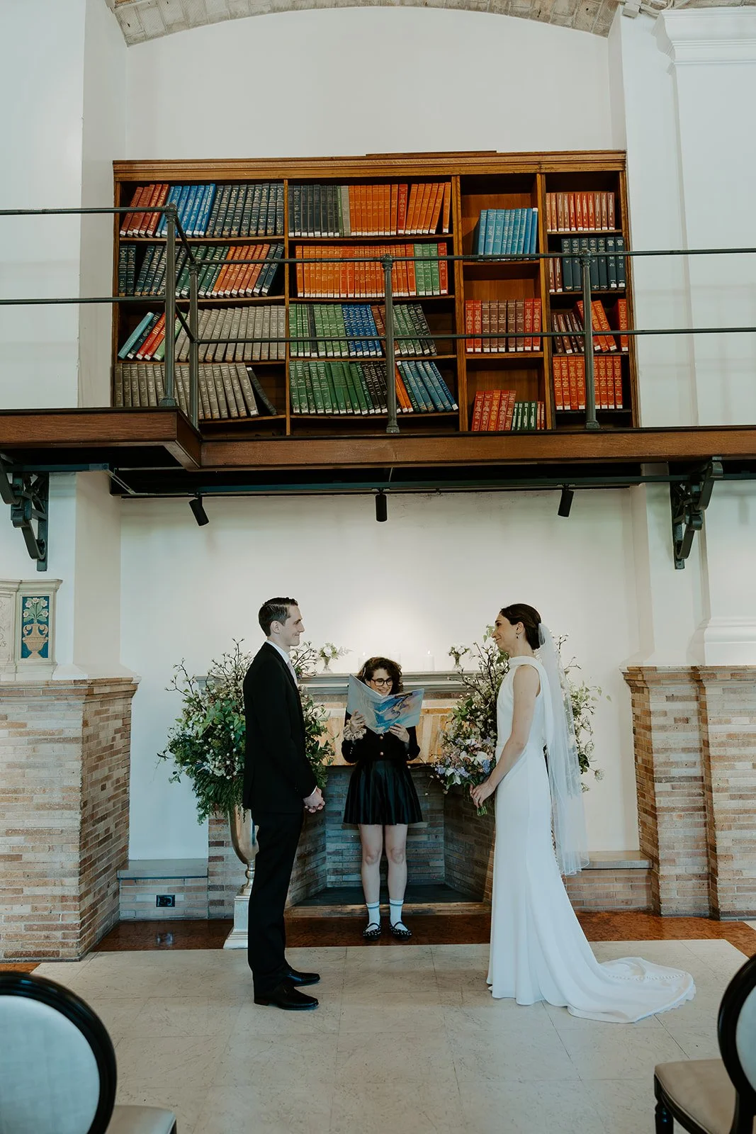 A bride and groom during the ceremony of their Boston Public Library elopement