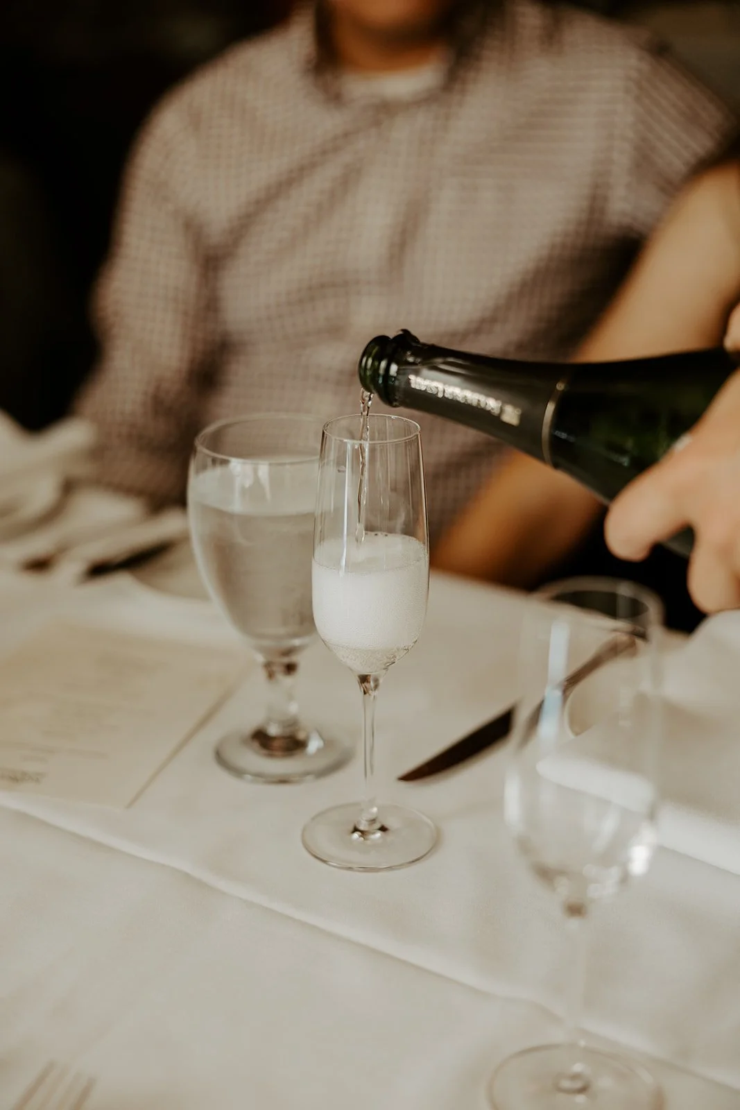 A waiter pouring champagne at a Boston elopement celebration