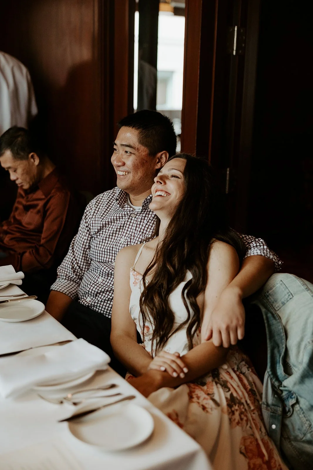 A candid photo of a couple laughing at their Boston elopement celebration