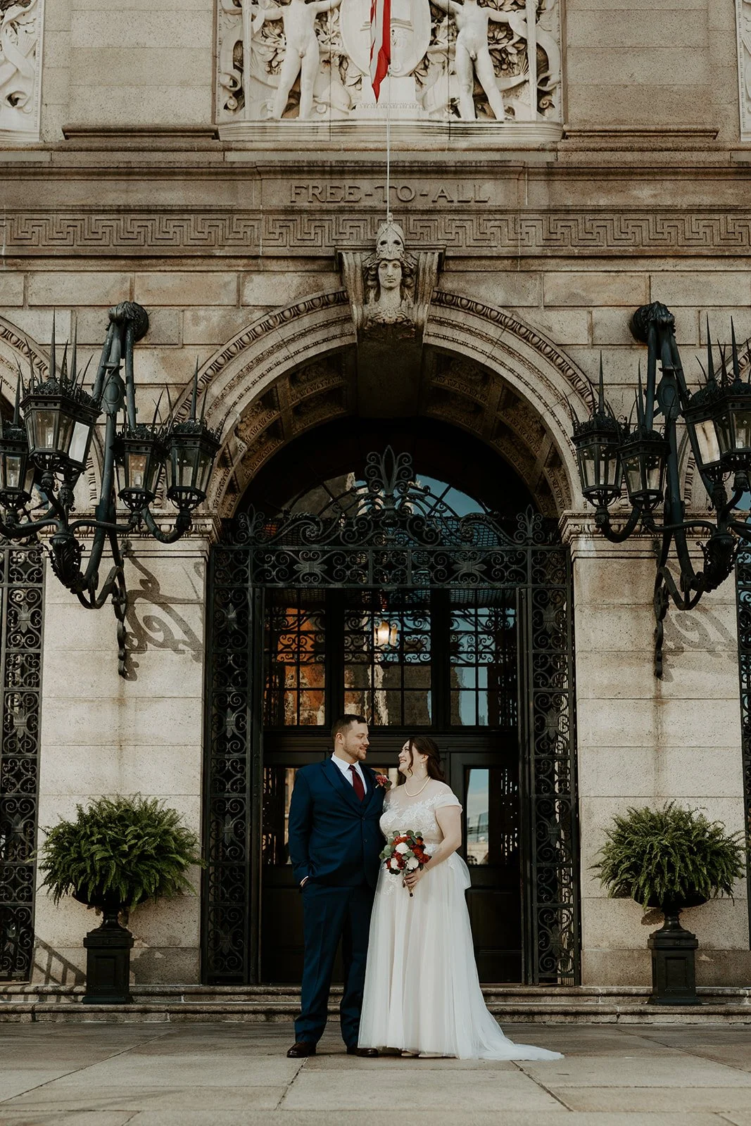 A bride and groom outside of the Library after their Boston Public Library wedding