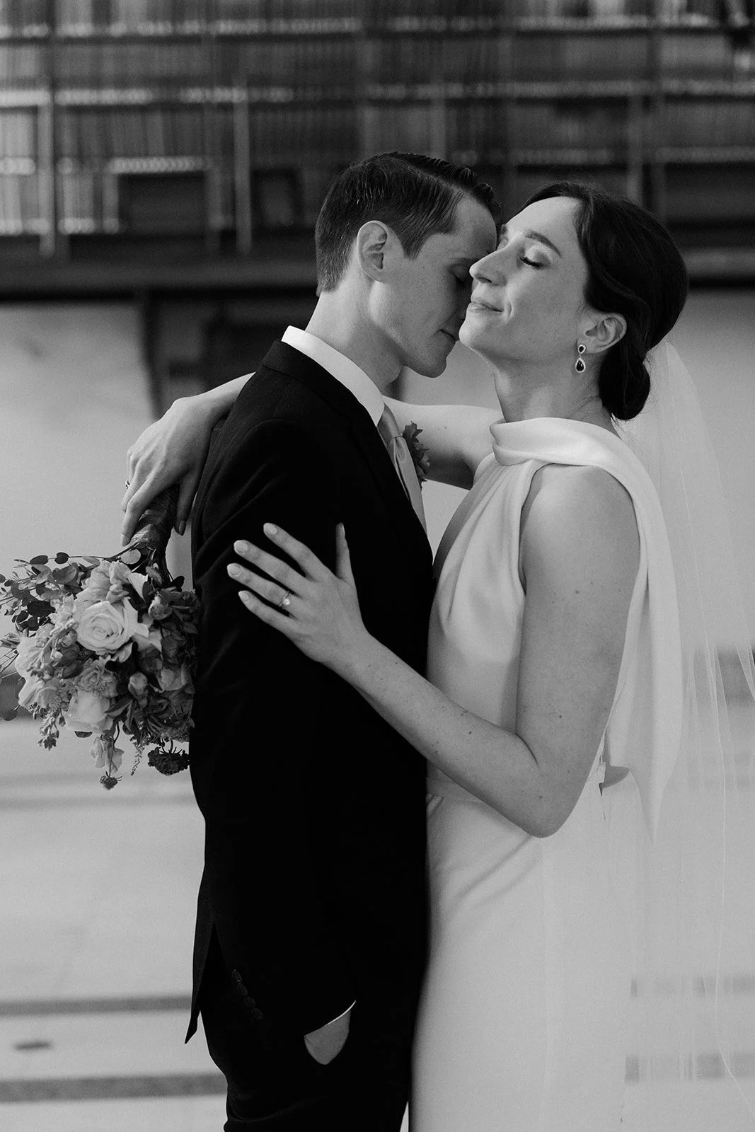 A man kissing his bride in Boston Public Library wedding photos