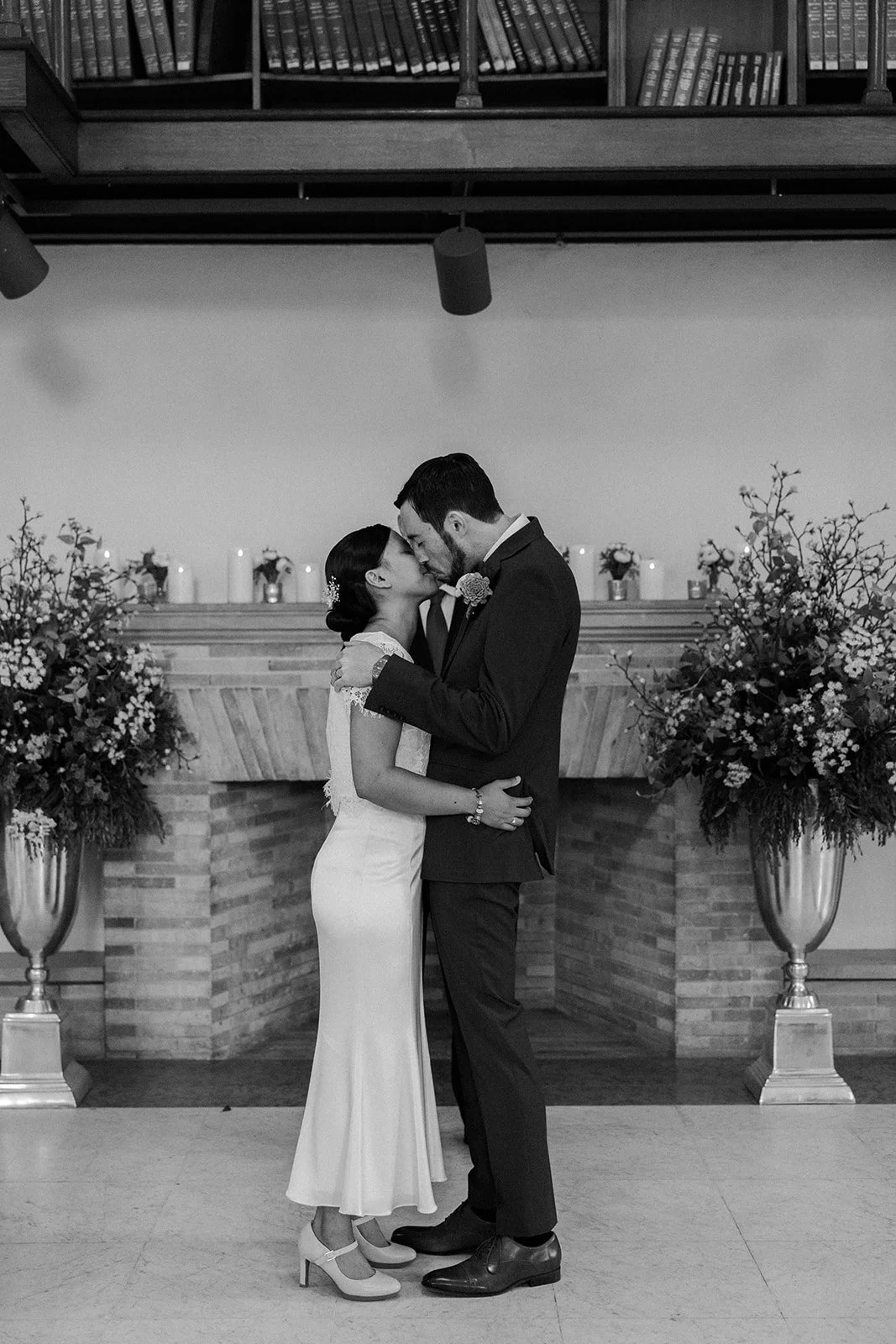 A bride and groom kissing during a Boston public library elopement ceremony