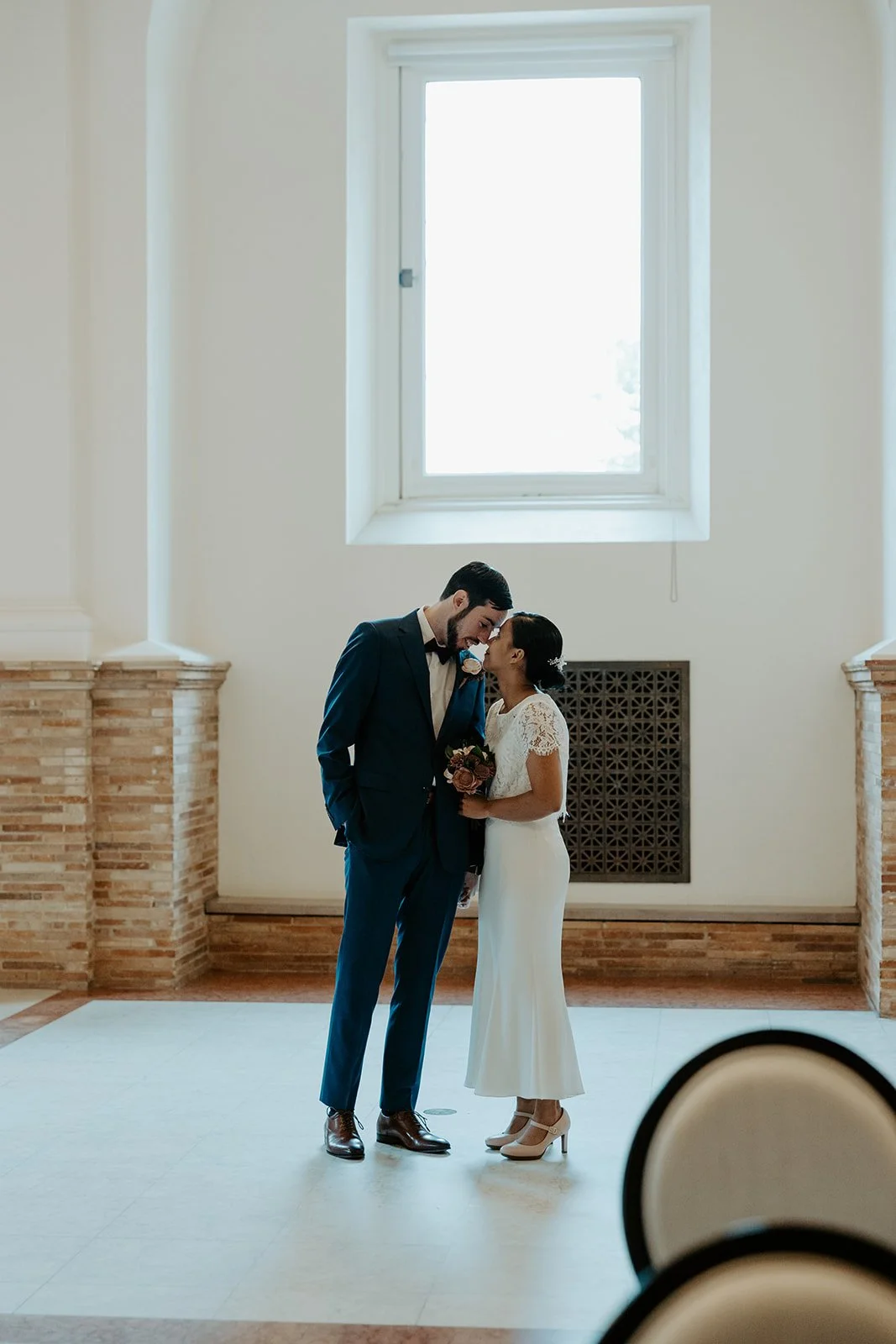 A bride and groom posing for wedding photos at their Boston Public Library wedding