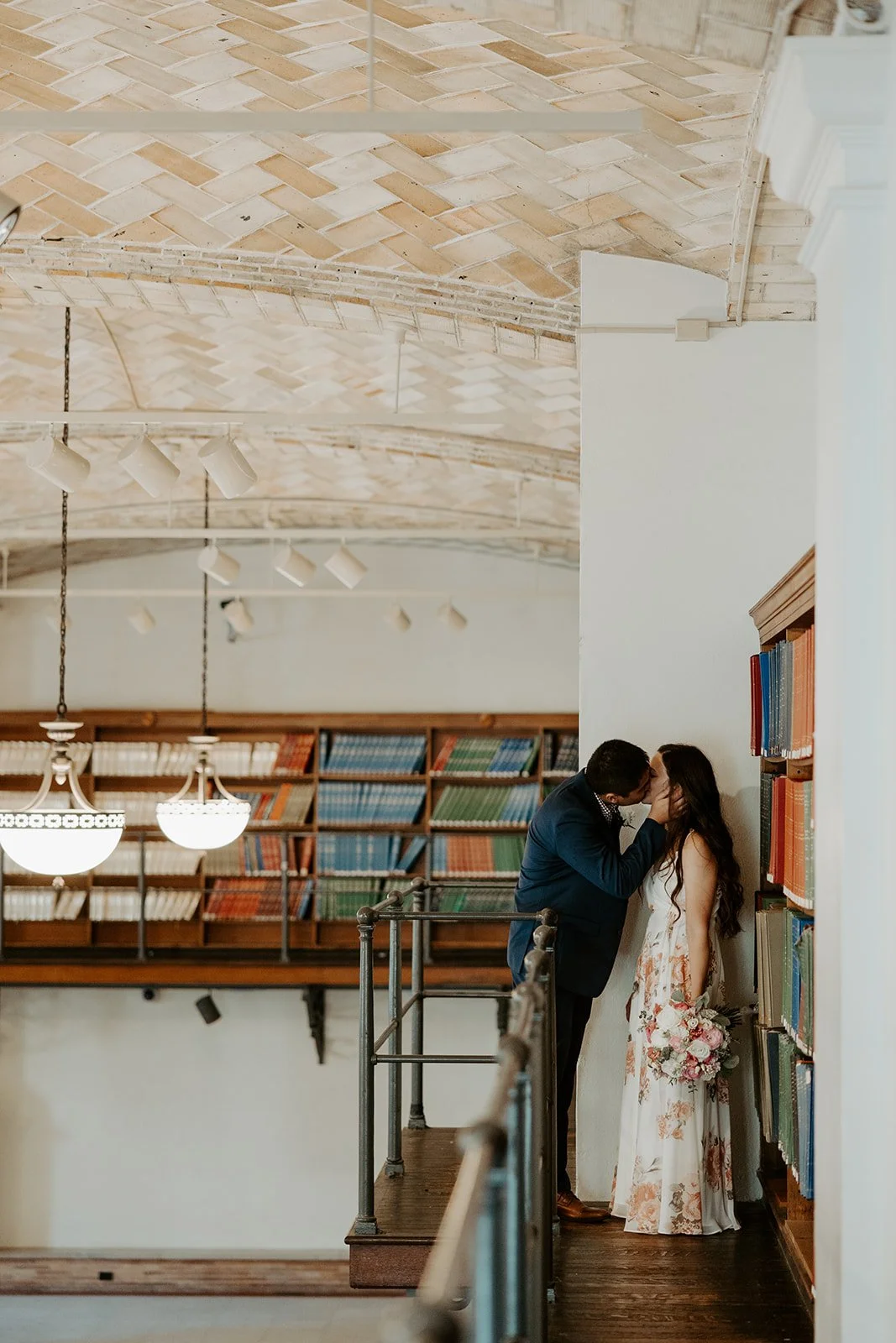 A couple posing for Boston Public Library elopement photos in the Guastavino Room