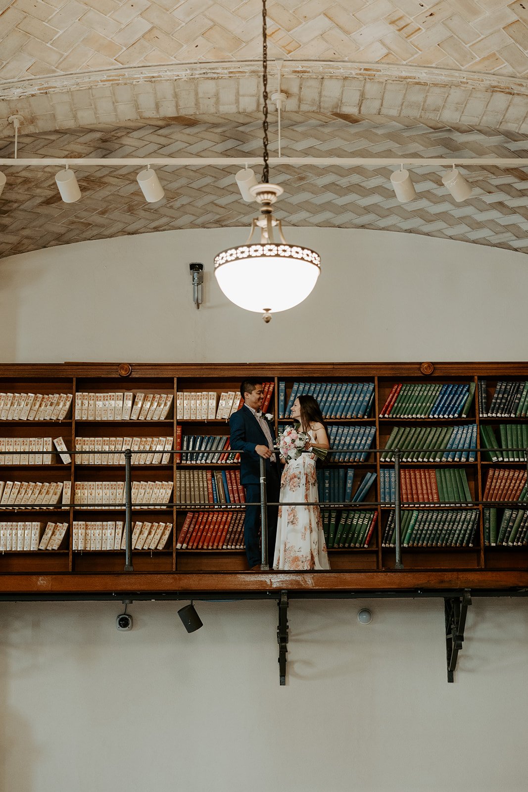 A couple posing for Boston Public Library elopement photos in the Guastavino Room