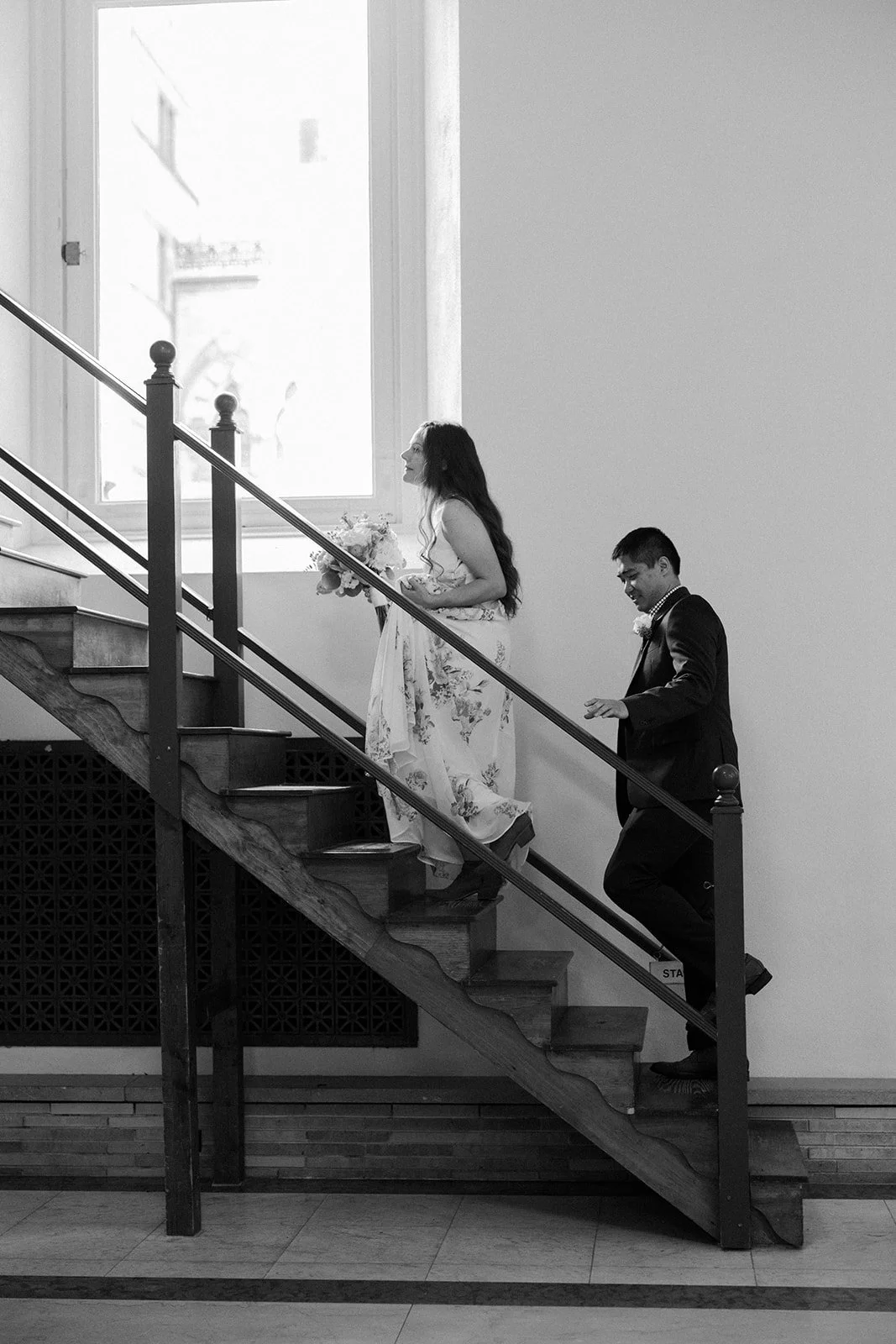 A couple walking up the stairs in the Boston public library Guastavino room