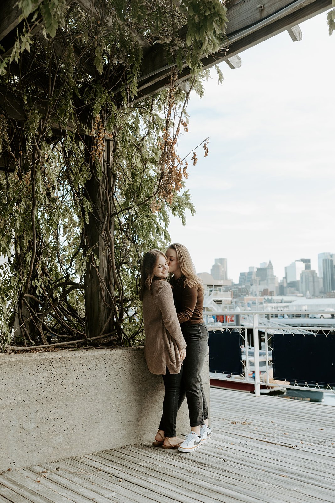 A couple posing for engagement photos in Charlestown, Boston