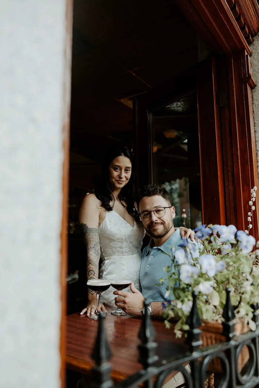 A couple posing for engagement photos in a cafe in North End