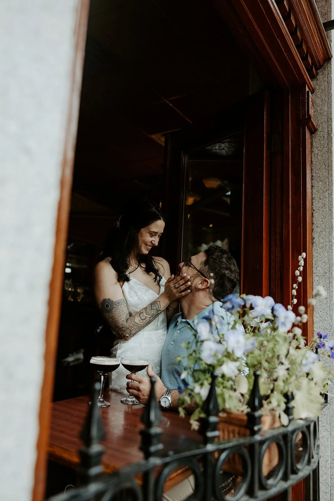 A couple posing for engagement photos in a cafe in North End