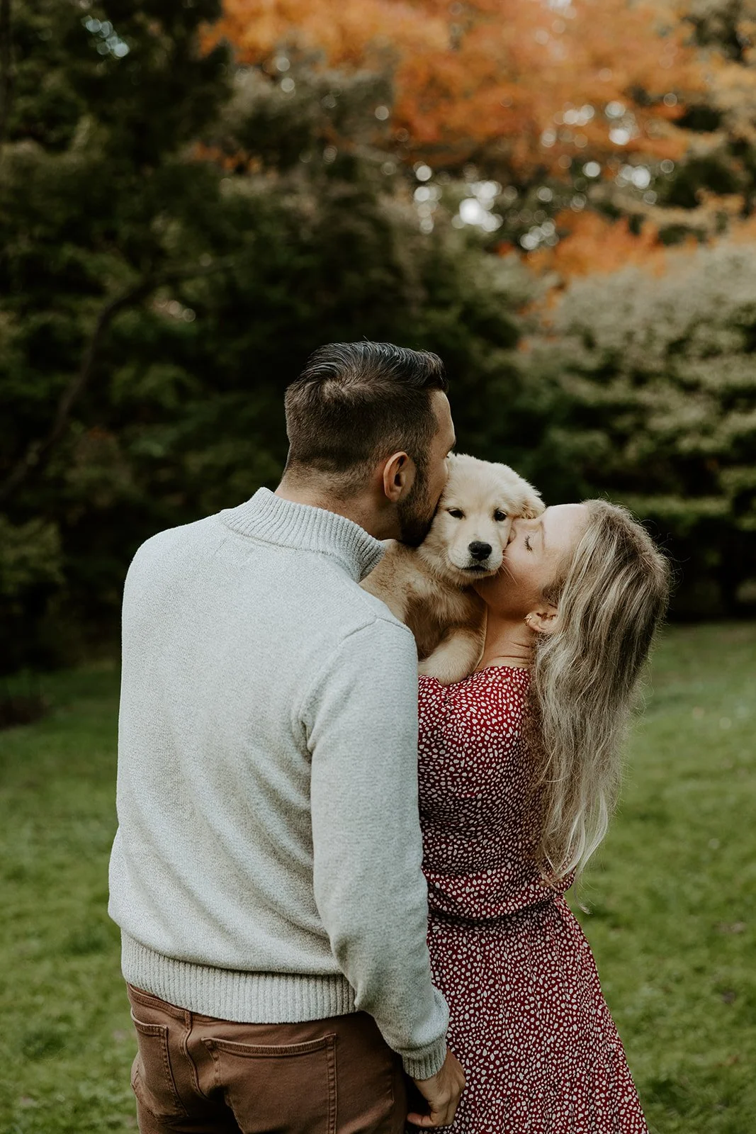 A couple posing for engagement photos at the Arnold Arboretum