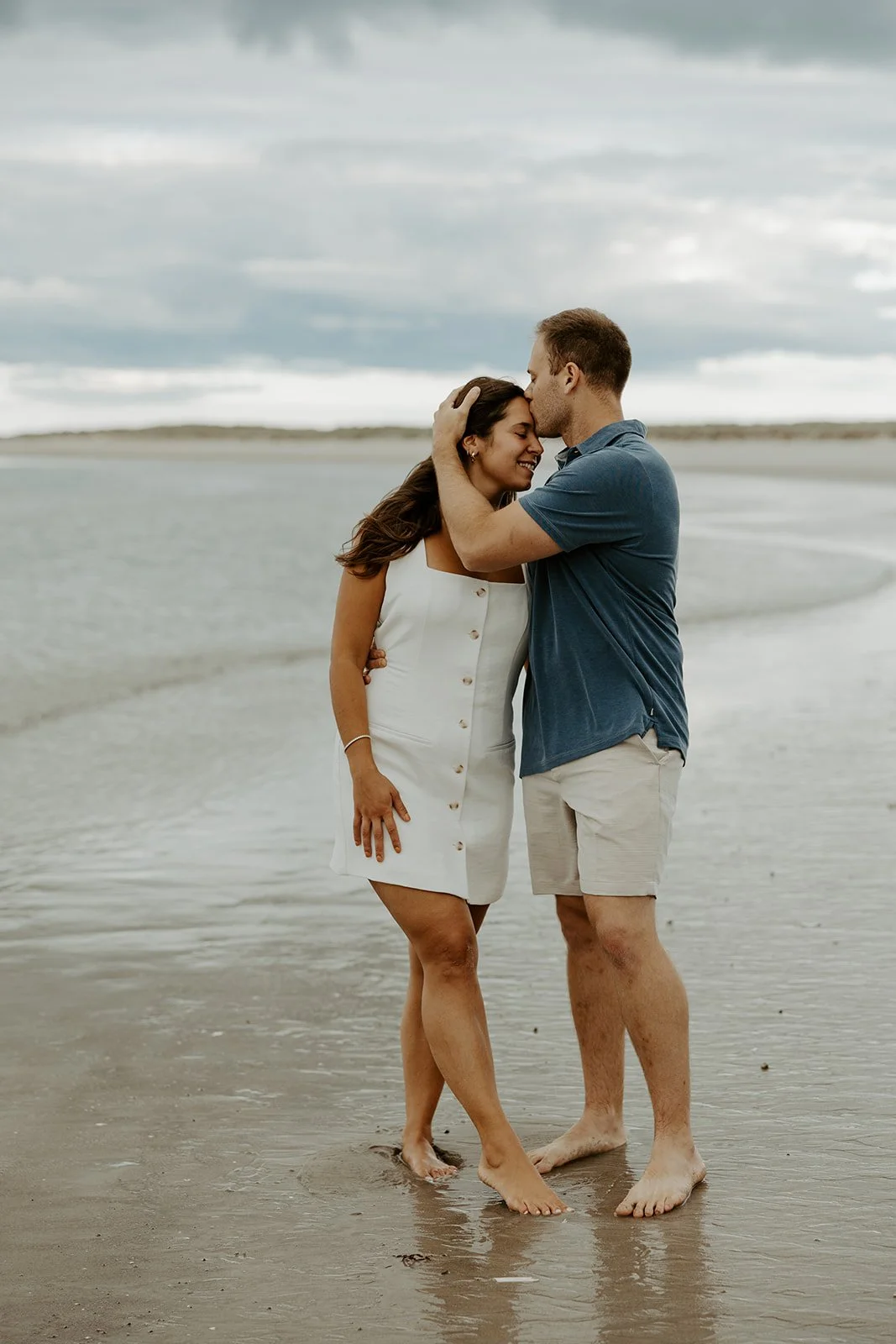 A couple posing for beach engagement photos at Crane Beach