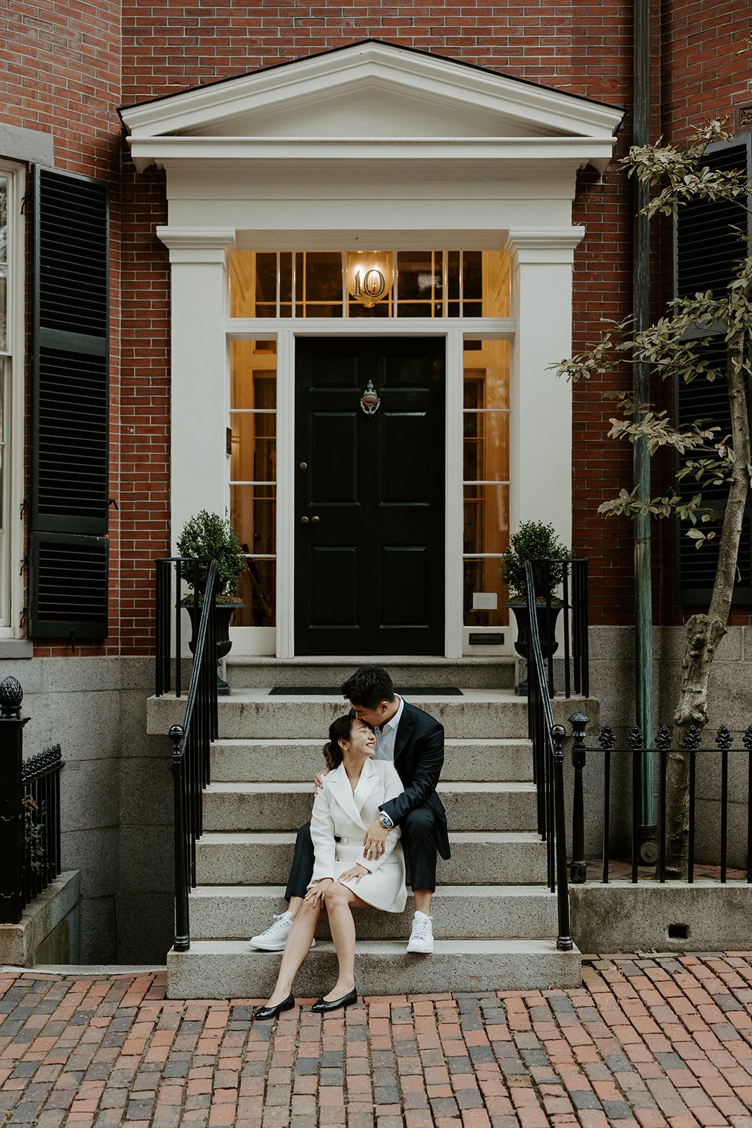 A couple on a stoop for Beacon Hill engagement photos