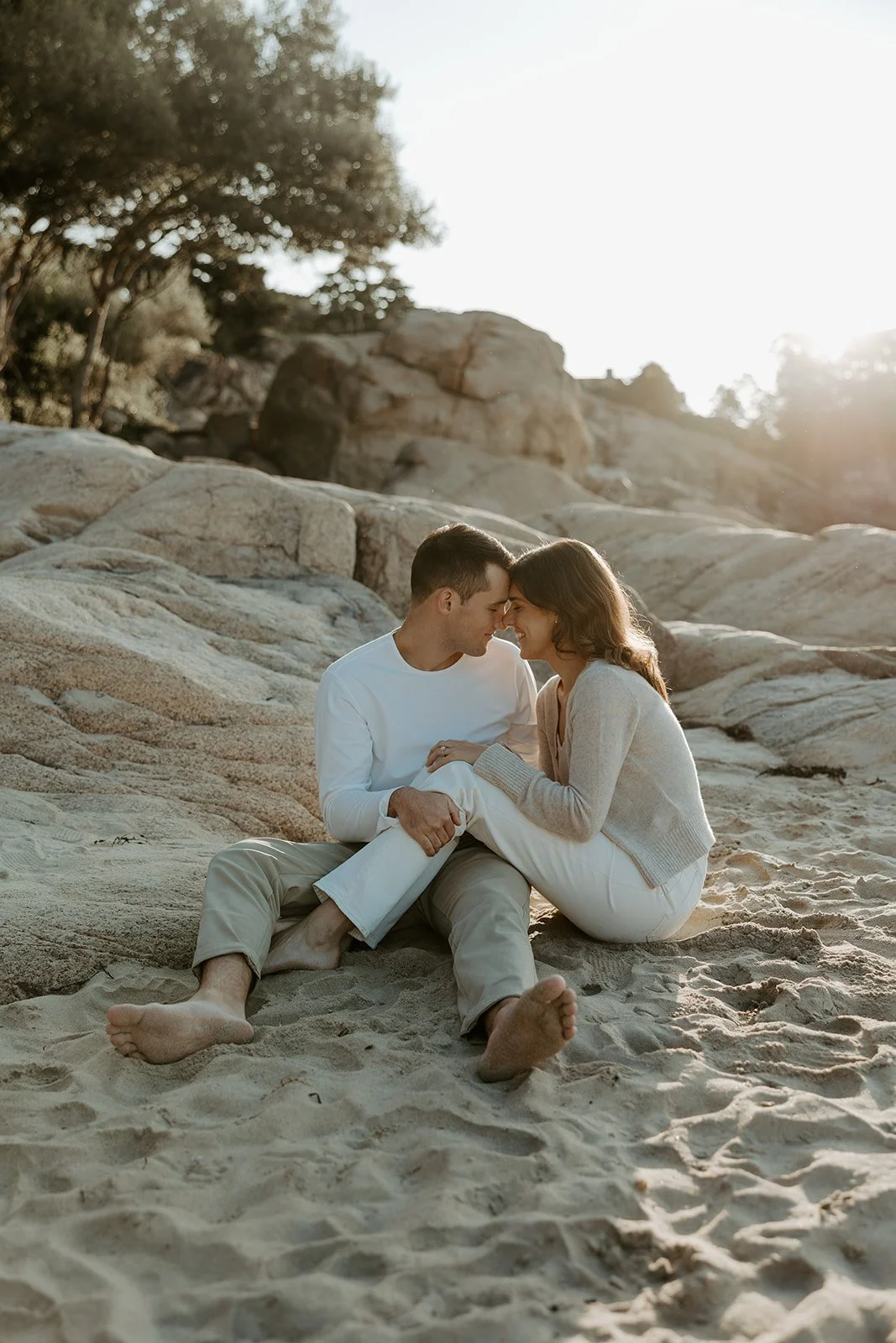 A couple taking beach engagement photos at Singing Beach 