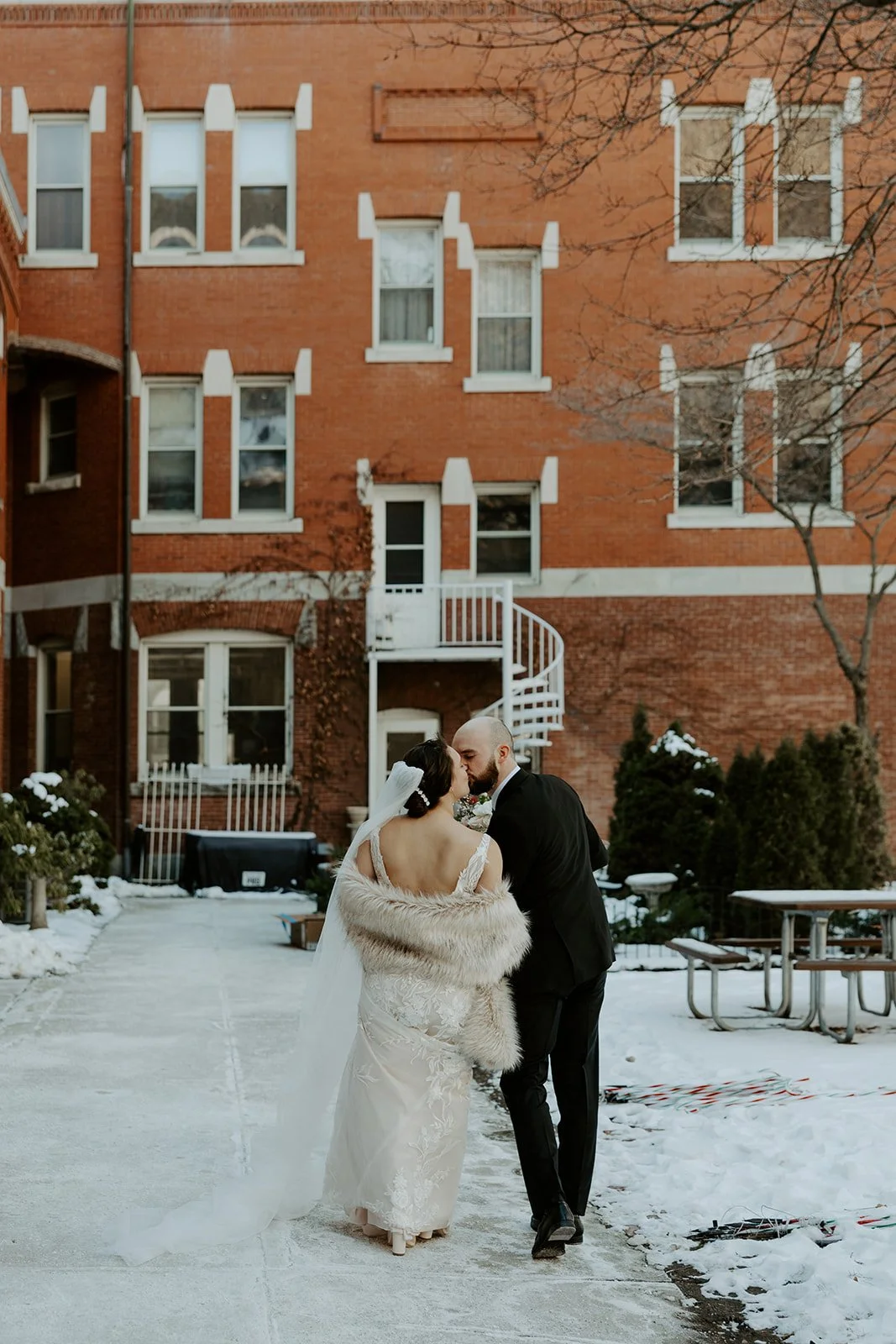 A bride and groom walking towards their wedding venue for their off season wedding