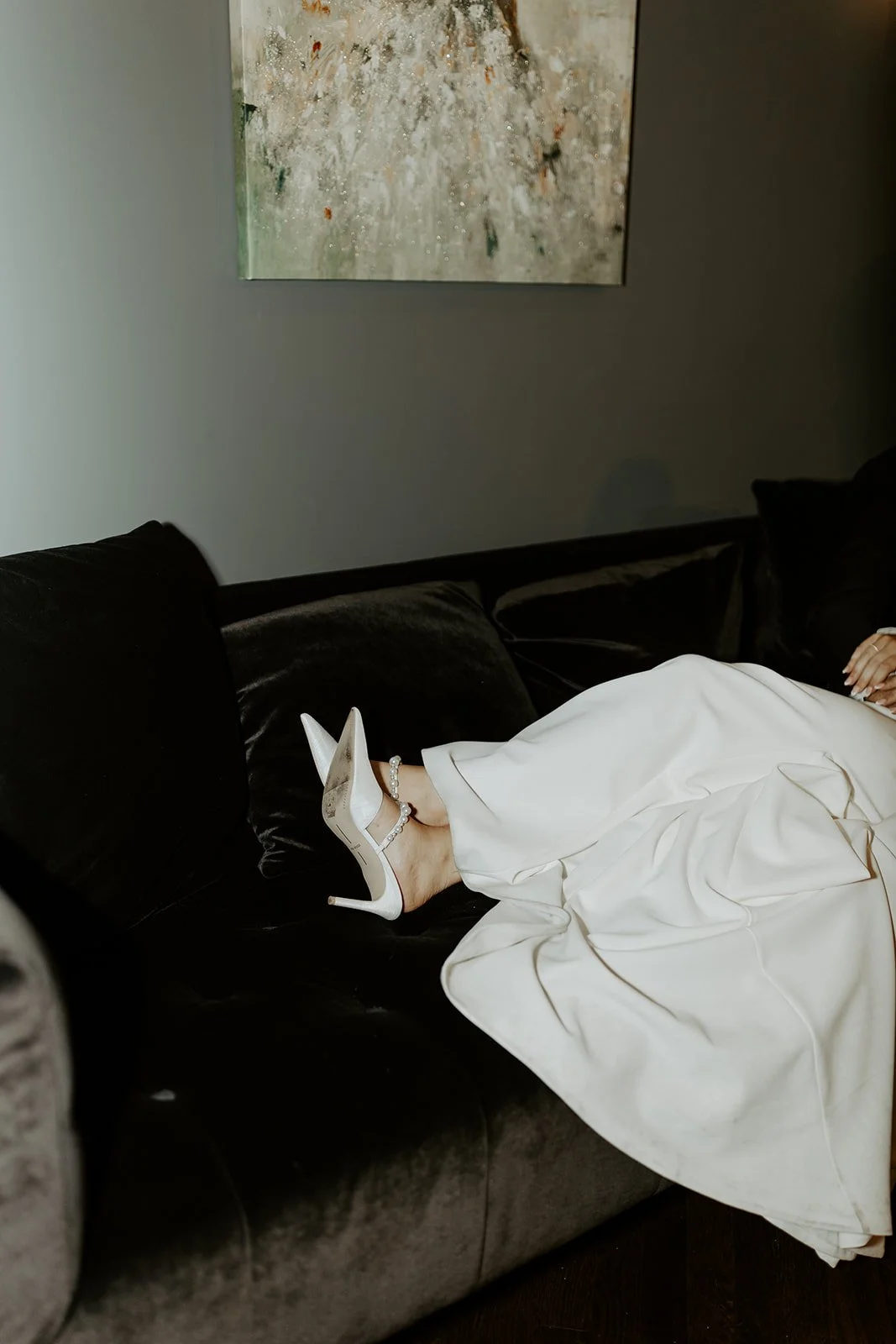 A bride's shoes on a couch for wedding photos