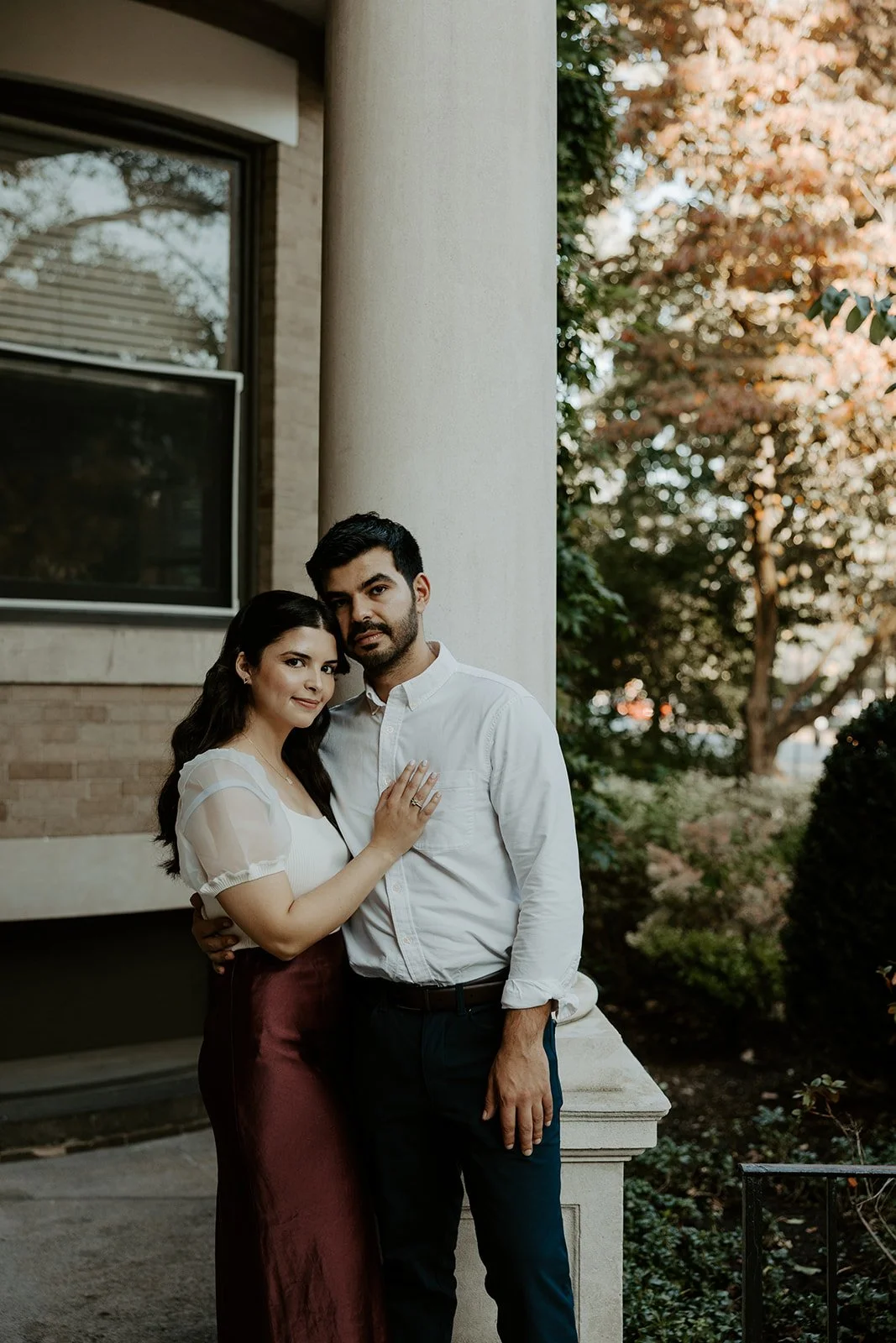 A couple posing for engagement photos in red showing what to wear for engagement photos