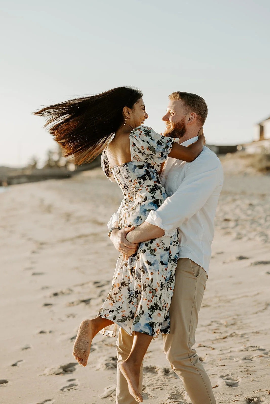 A couple showing what to wear for beach engagement photos