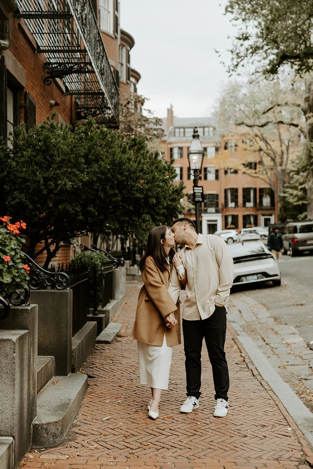 A couple kissing while taking engagement photos