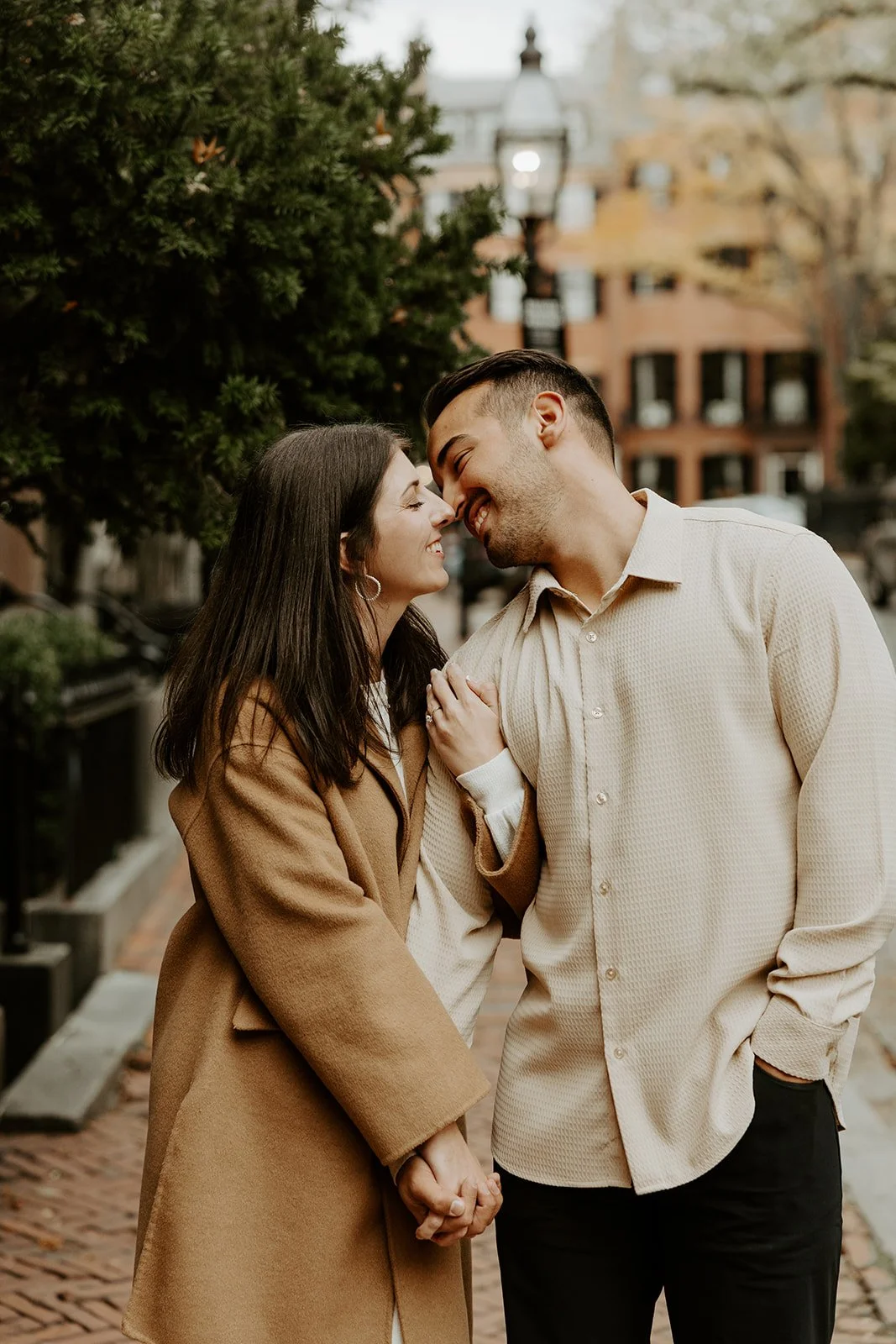 A couple kissing while taking engagement photos