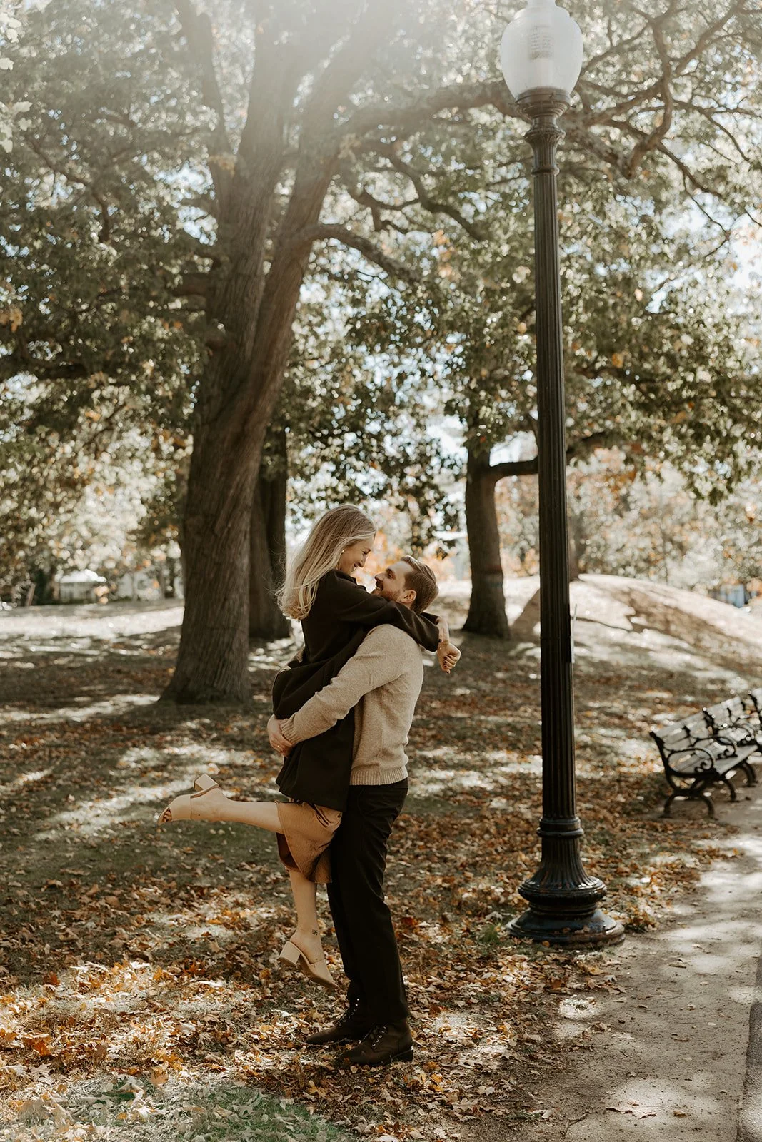 A couple walking through a park showing what to wear for engagement photos