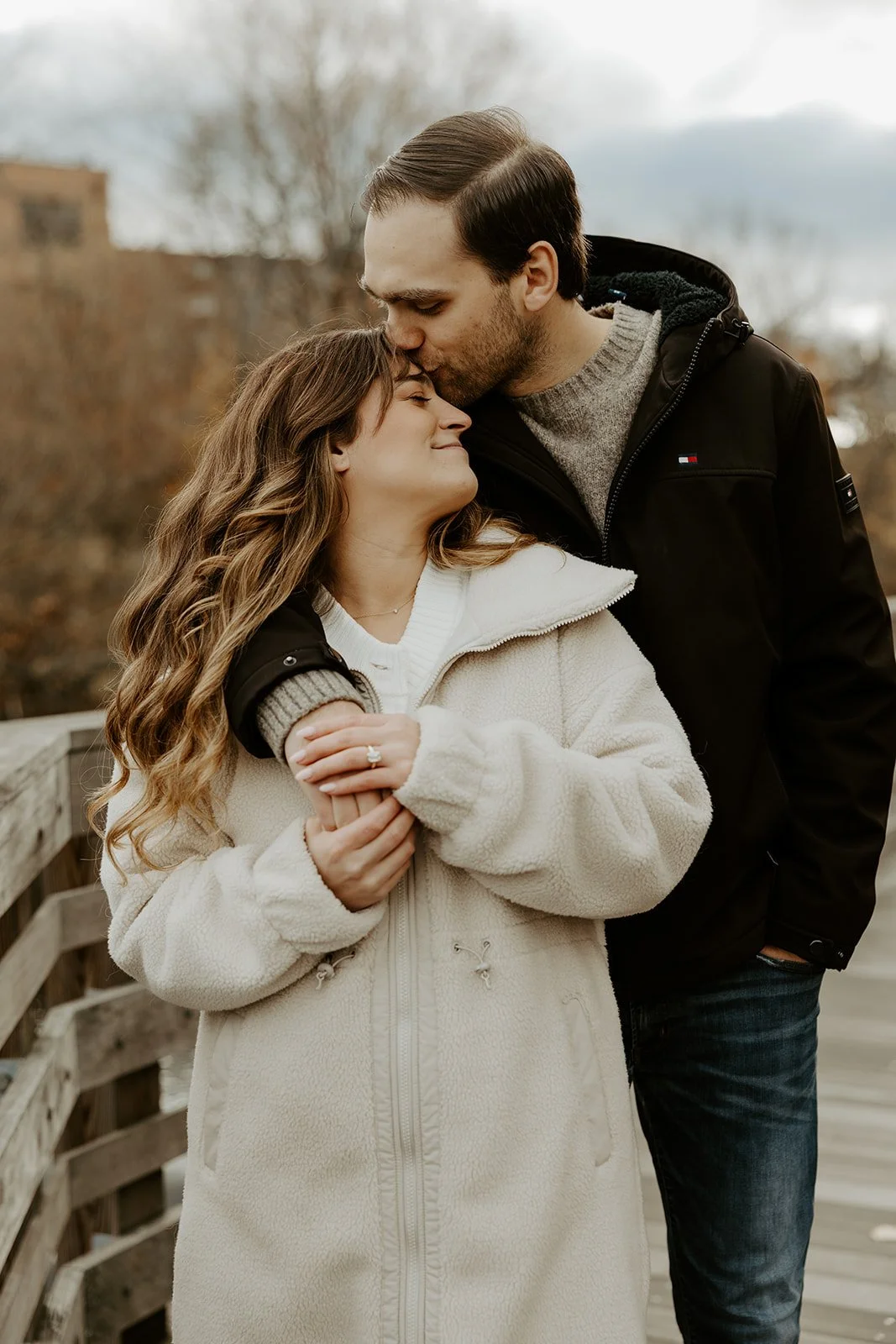 A couple posing for winter engagement photos