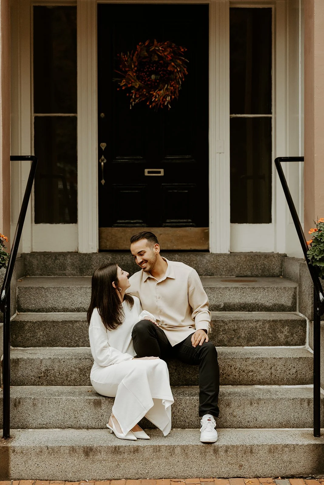 A couple posing on steps for Boston engagement photos