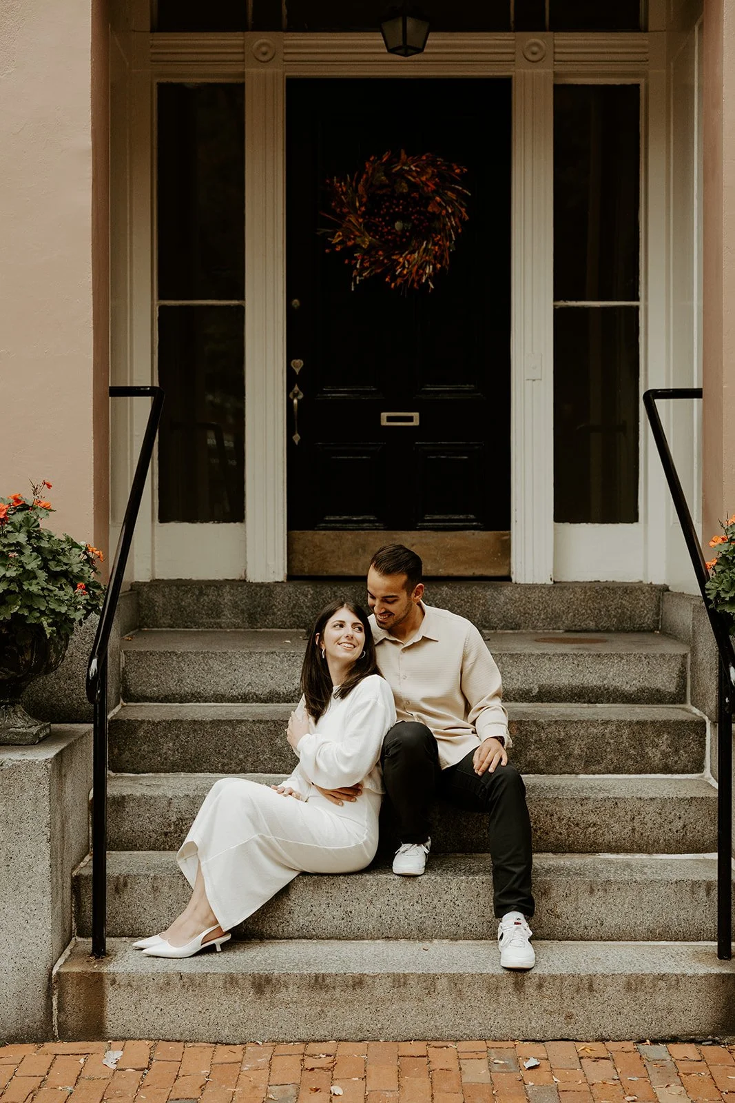 A couple posing on steps for Boston engagement photos