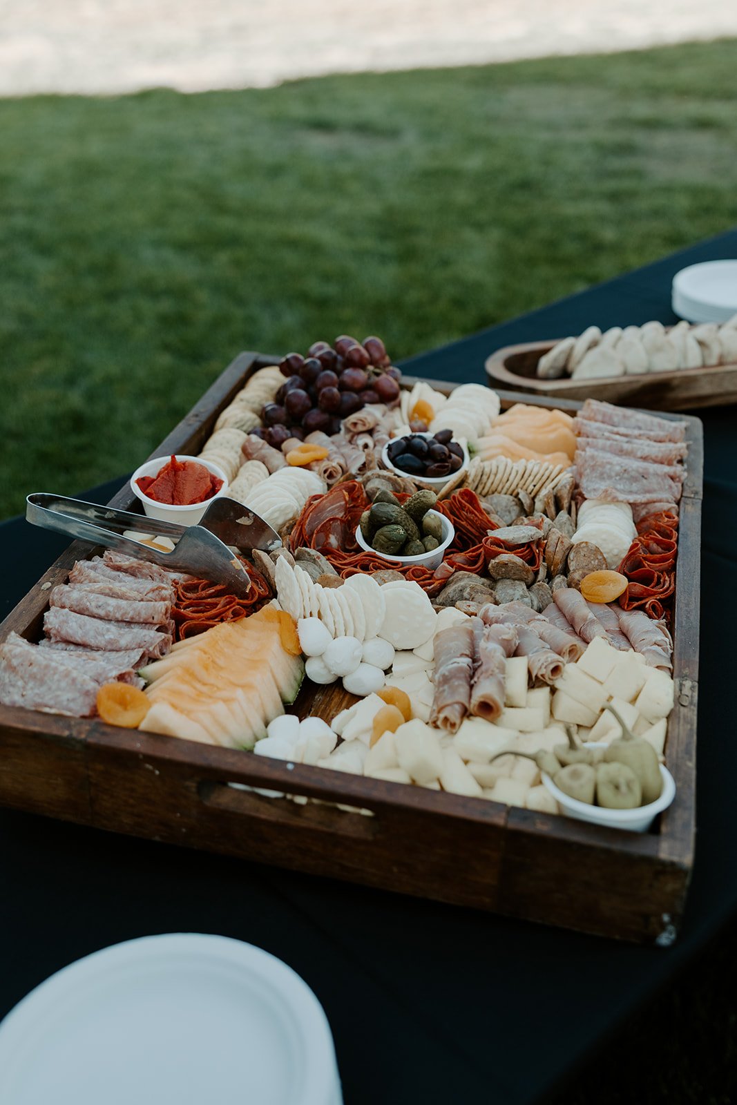 A charcuterie station at a backyard wedding, as ideas for a backyard wedding