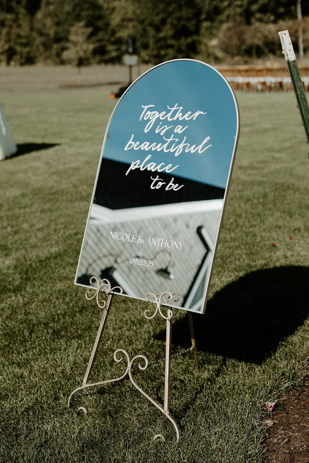 A mirror welcome sign at a wedding