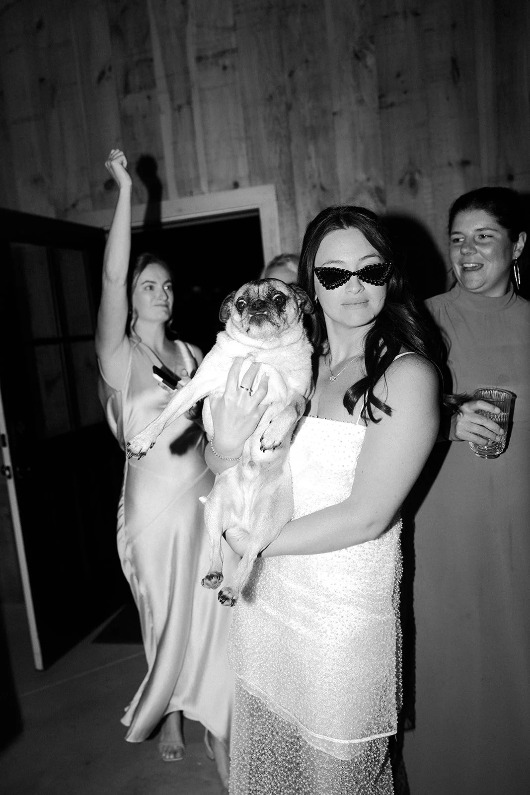 A bride dancing with her dog at her wedding reception
