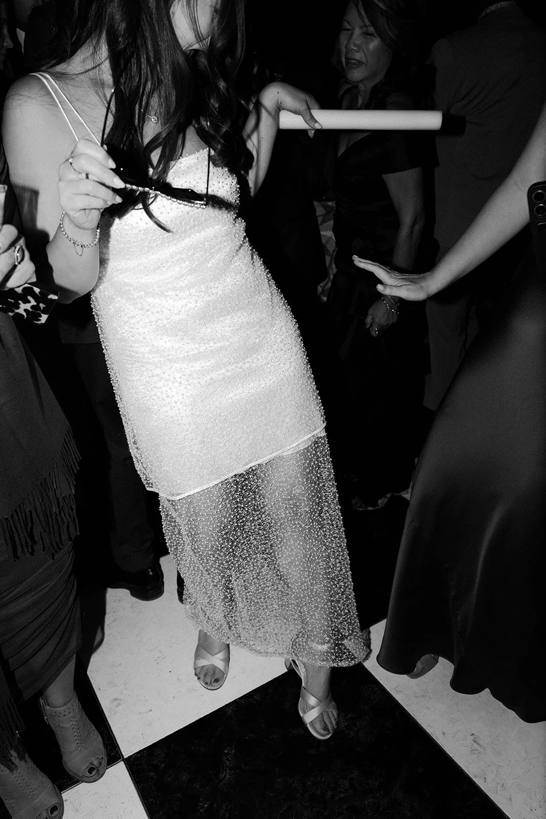 A bride dancing in her wedding reception dress at a backyard wedding