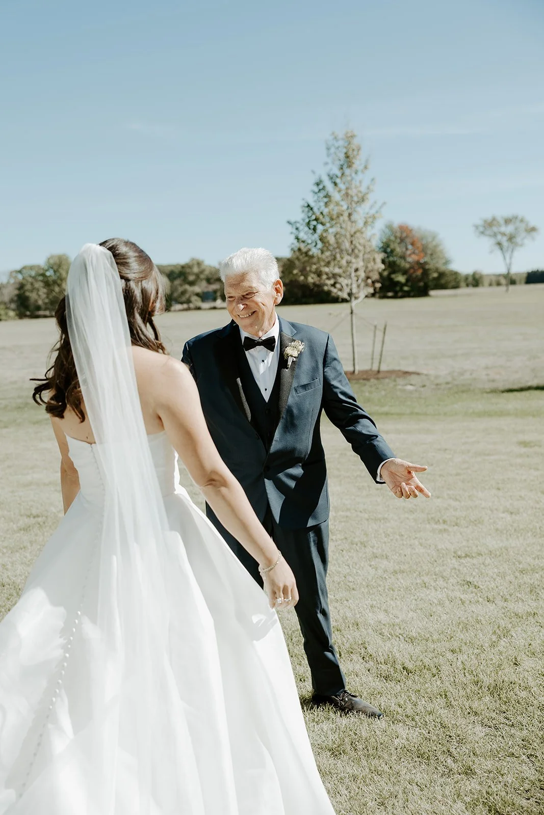 A father reacting to his daughter in a wedding dress