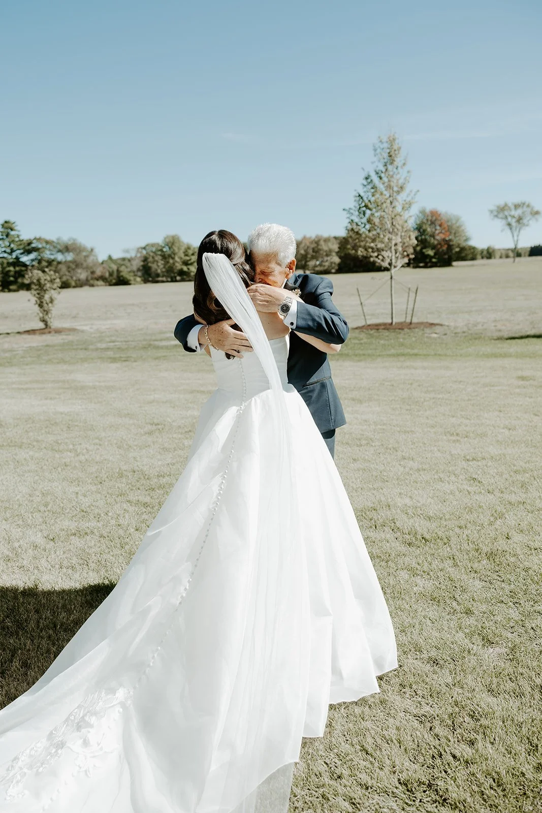 A father reacting to his daughter in a wedding dress