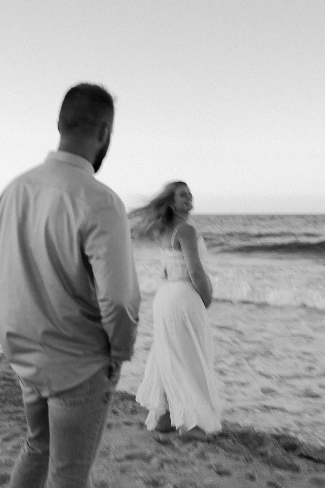 A couple dancing on the beach for maternity photos