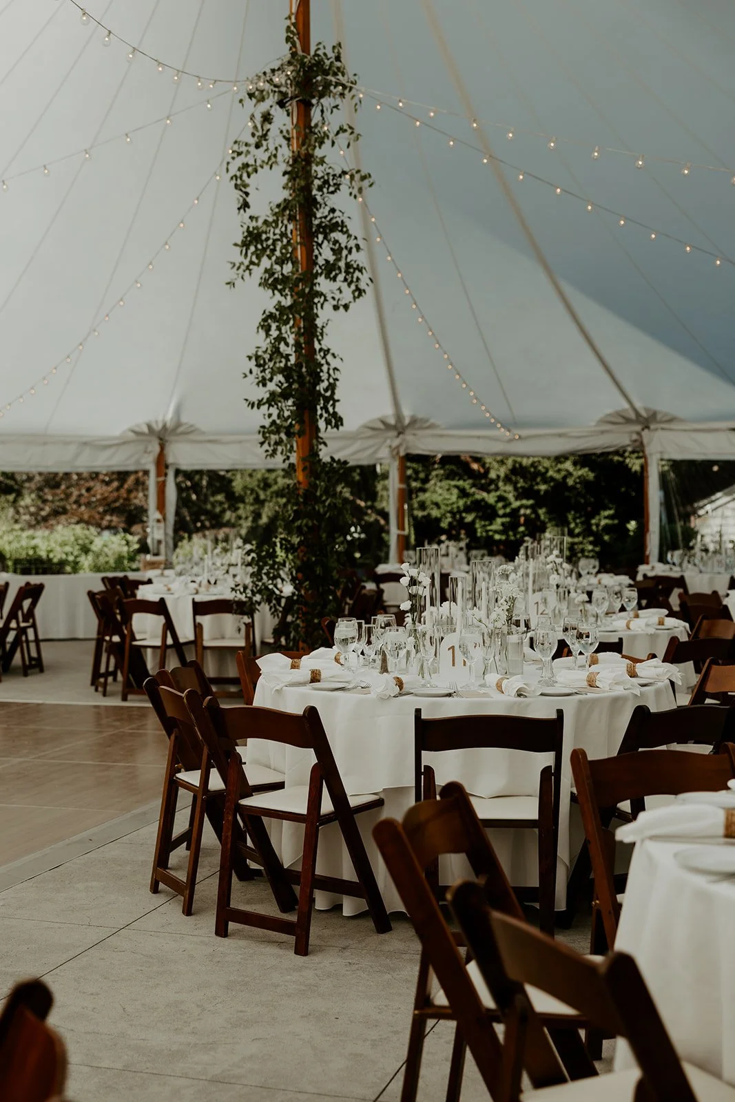 A wedding reception setup under a tent